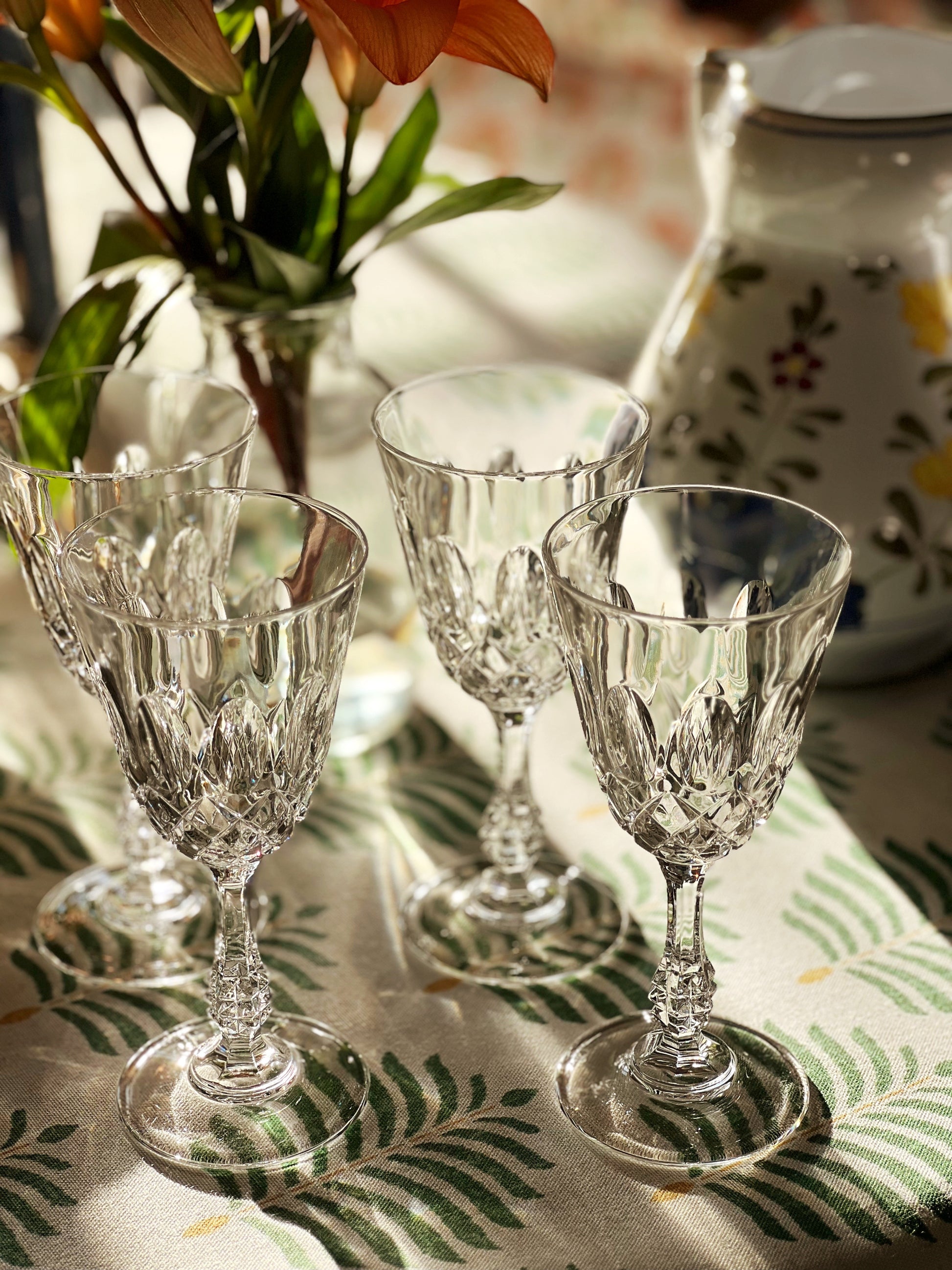 crystal wine glasses on a sun drenched table