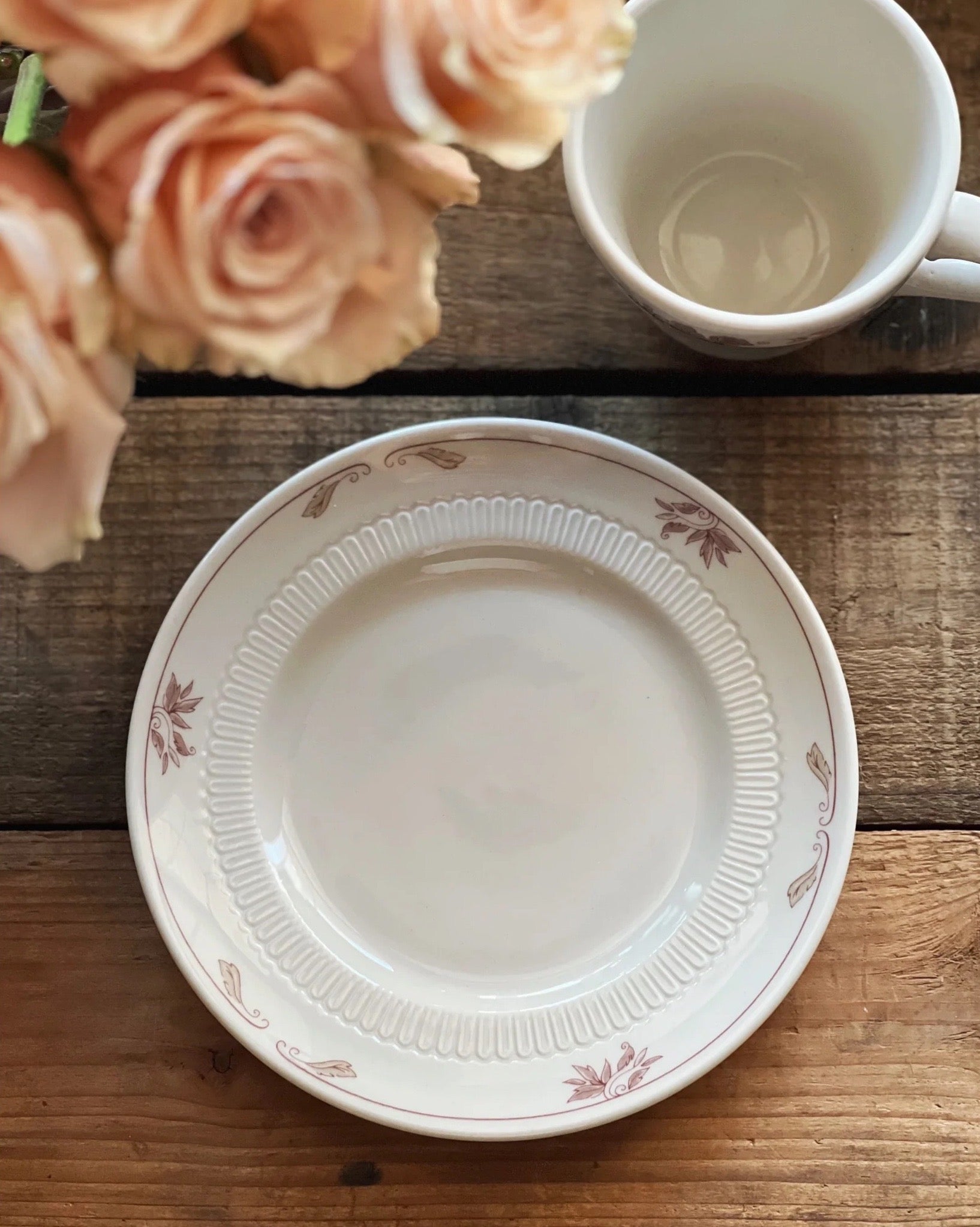 white plate with a pinkish purple floral design around the edge