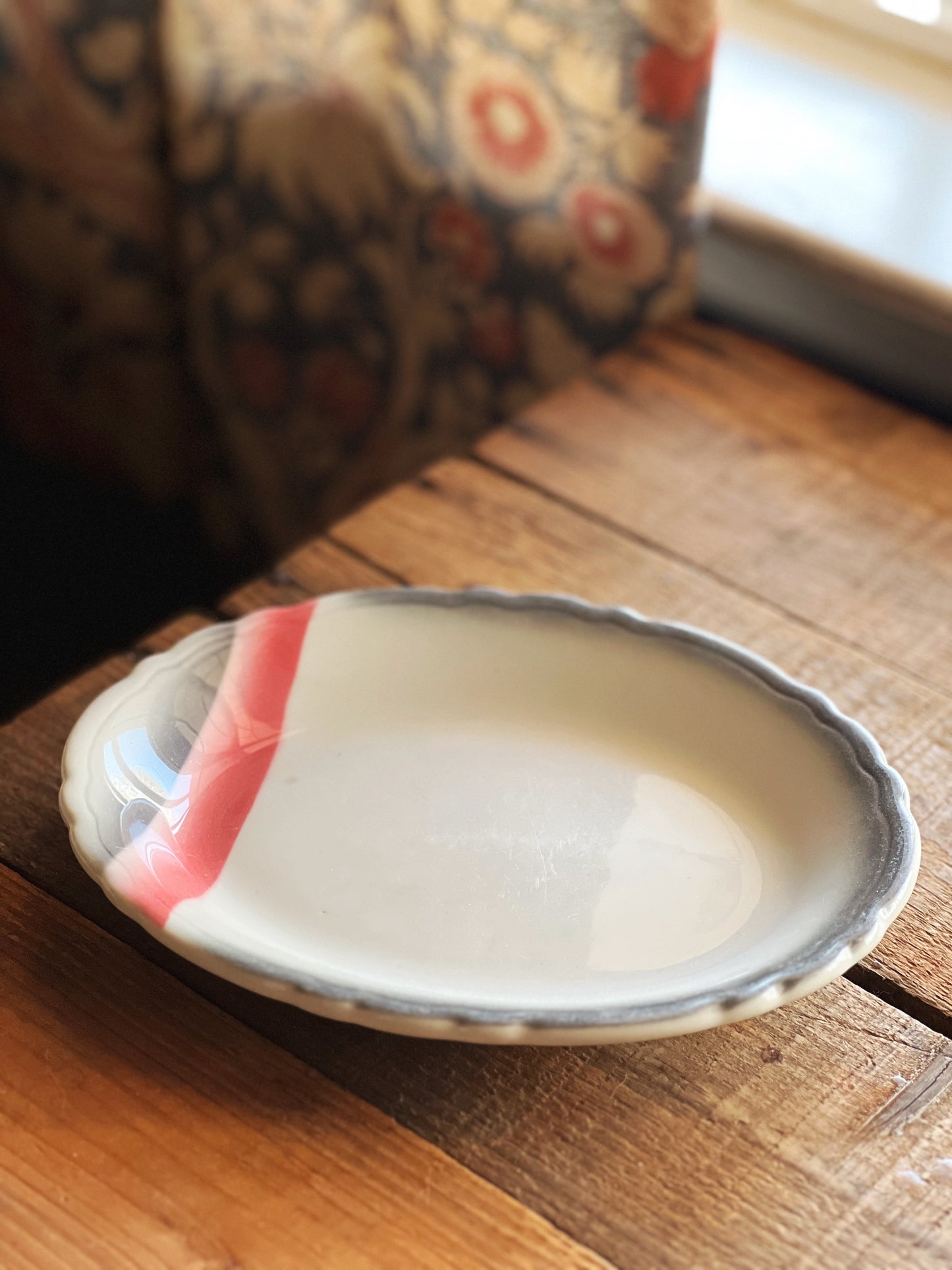 small pink and gray platter with a scalloped edge