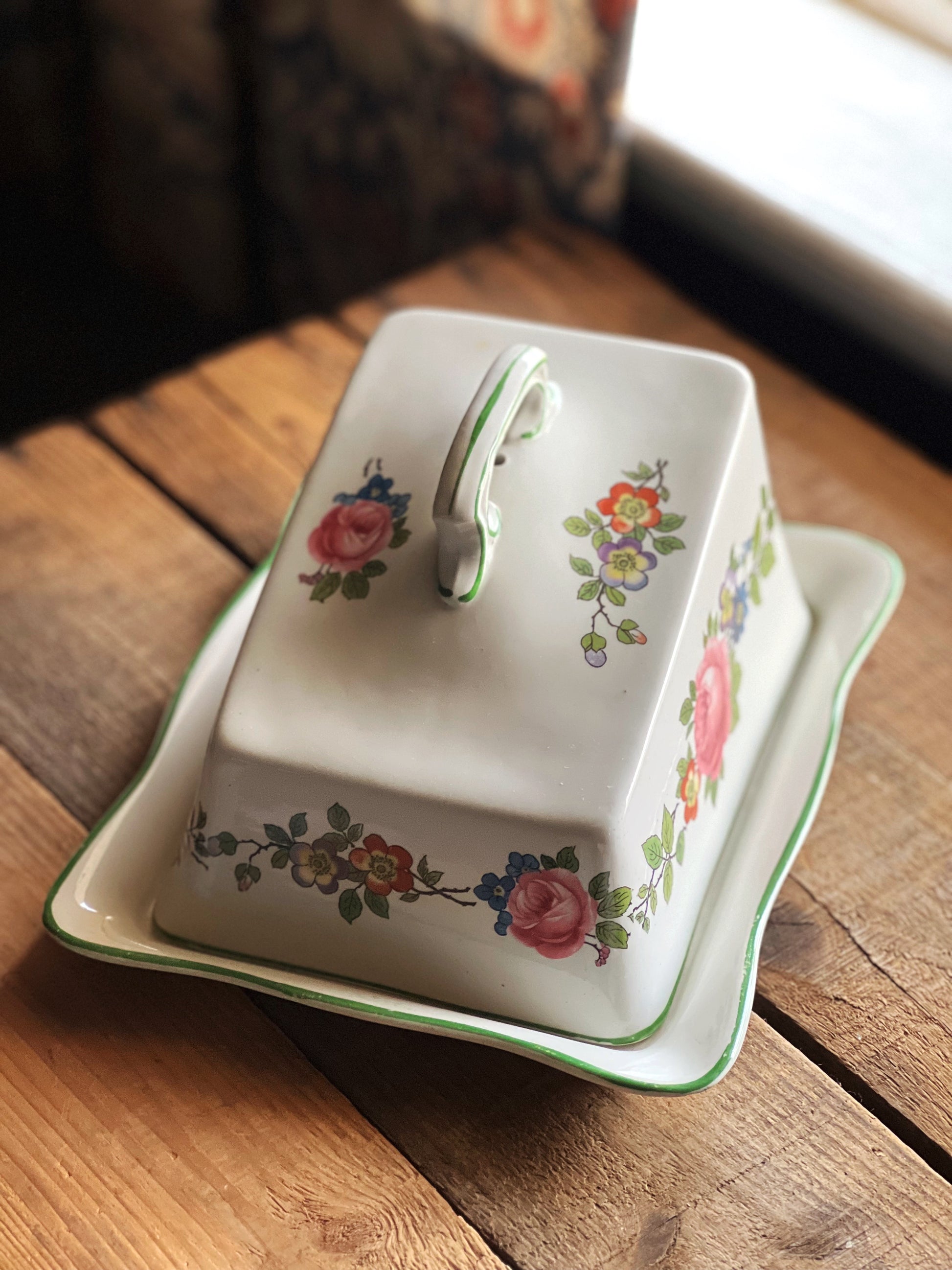 multi color floral cheese dish trimmed in green