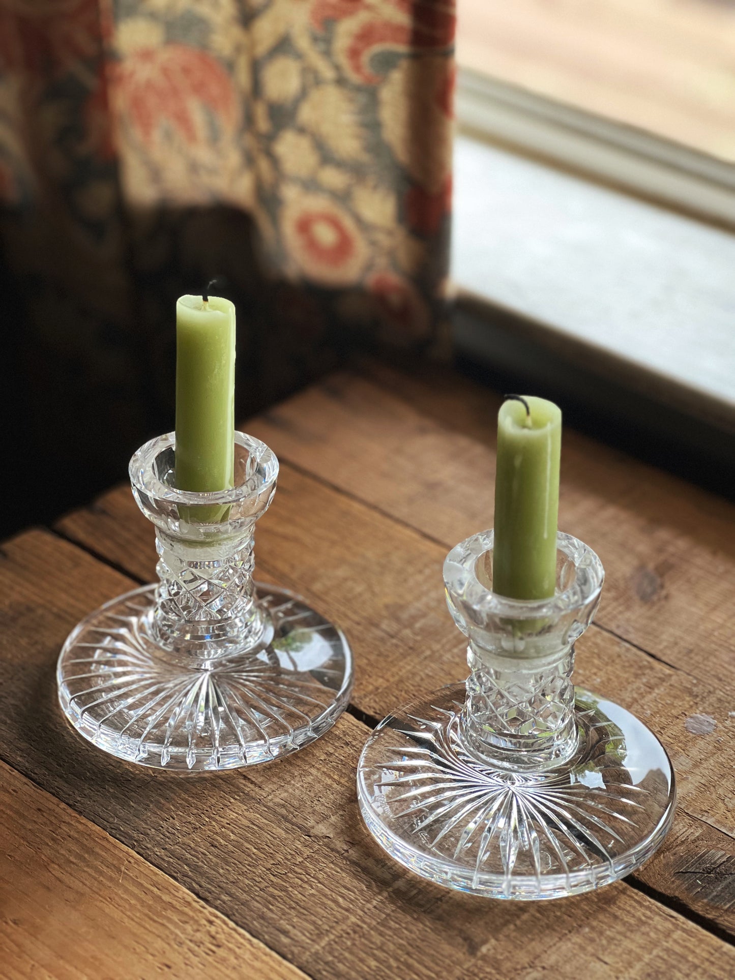 pair of Waterford crystal candleholders on a wooden table