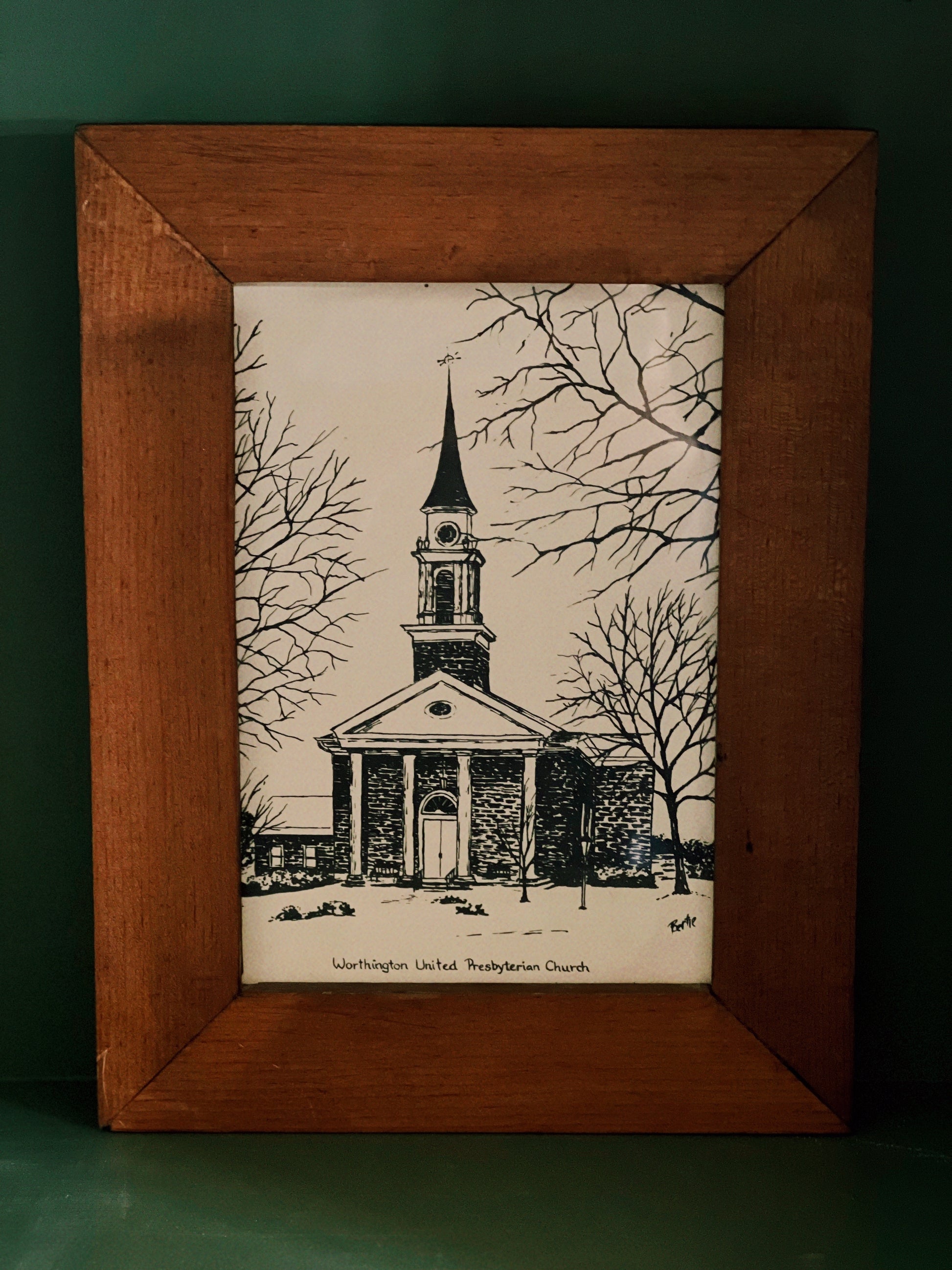 Framed artwork of a church with a steeple on a white background