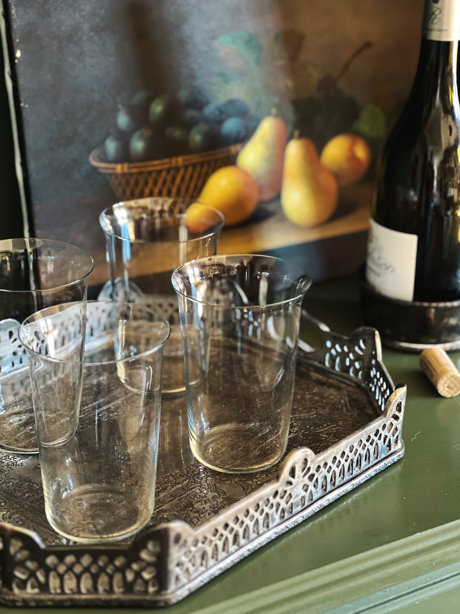 4 clear glass tumblers on a silver tray