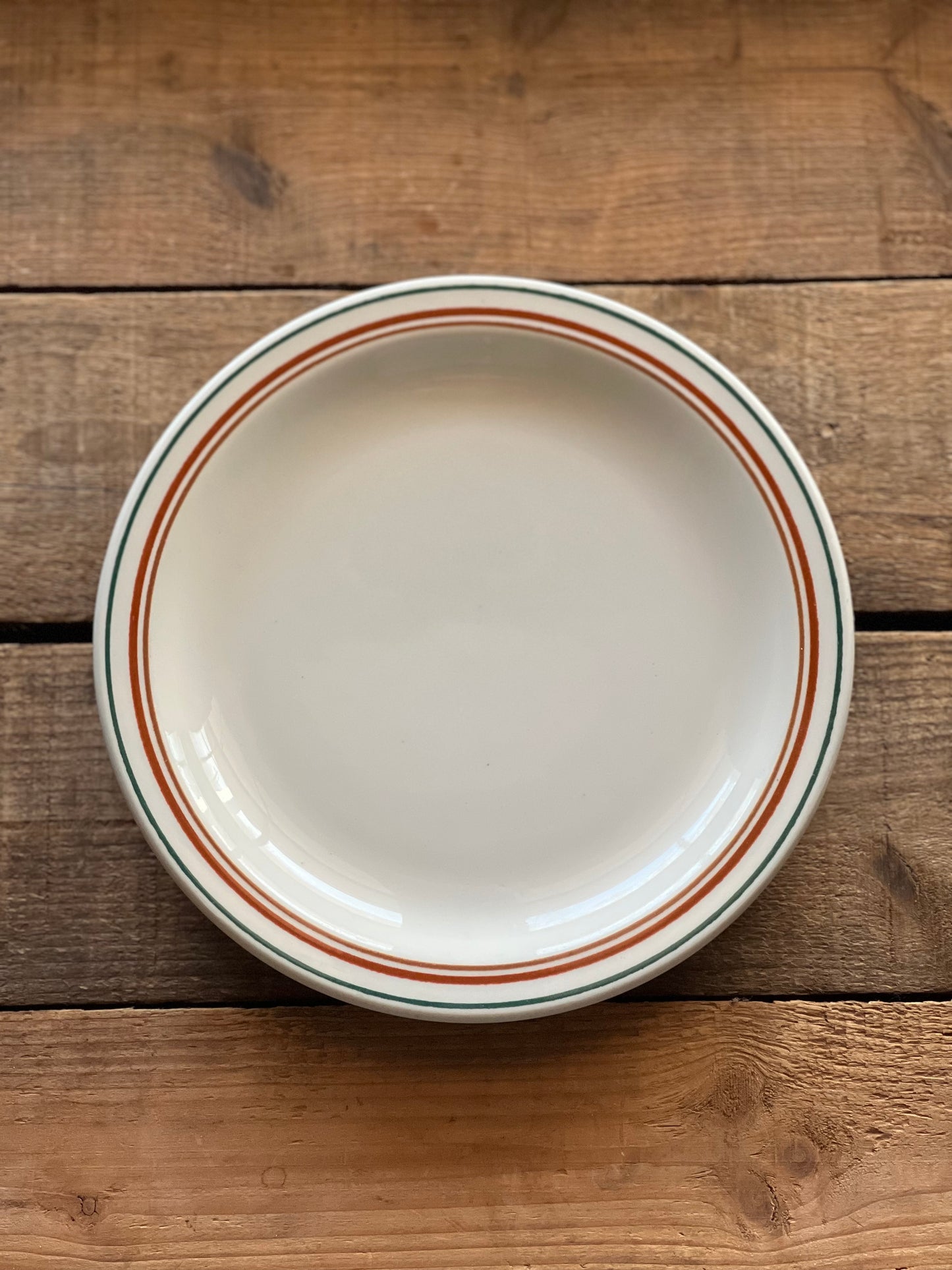 Buffalo china plate with a red and green stripe rim