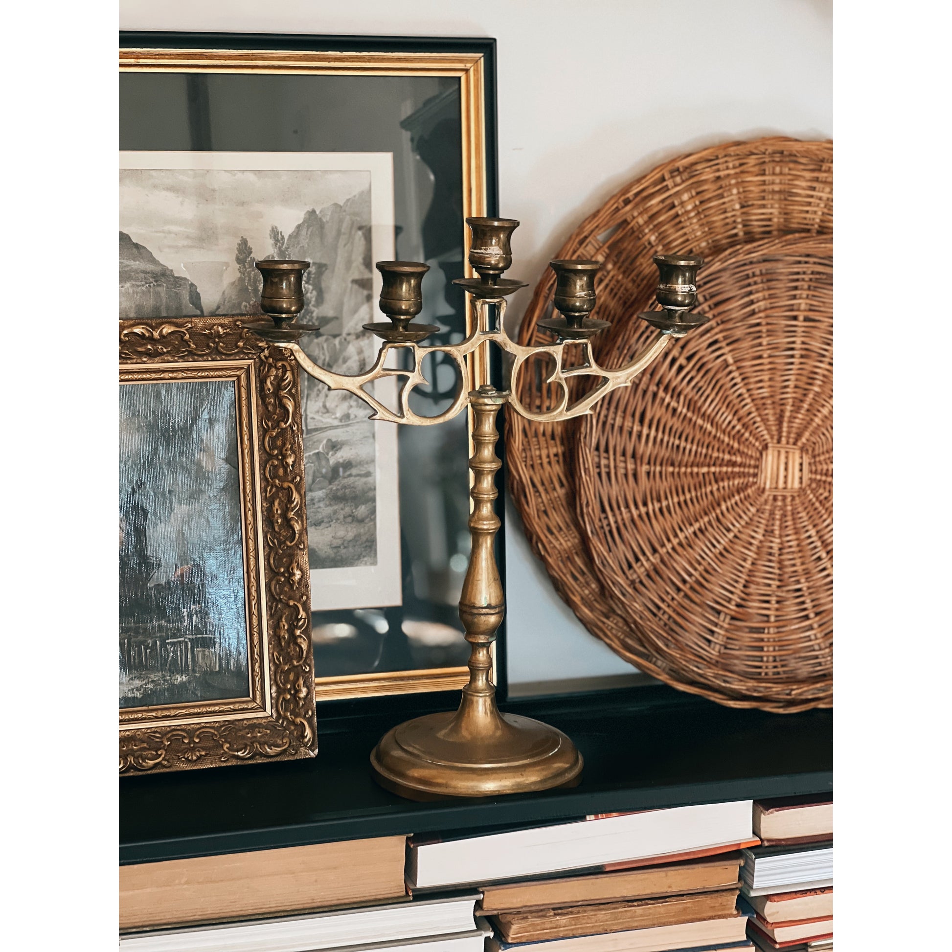 brass 5 arm candelabra on a shelf