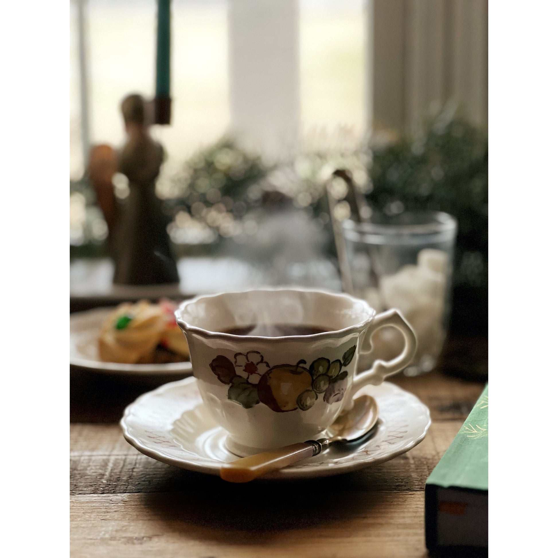 vintage teacup & saucer with a steaming cup of tea inside