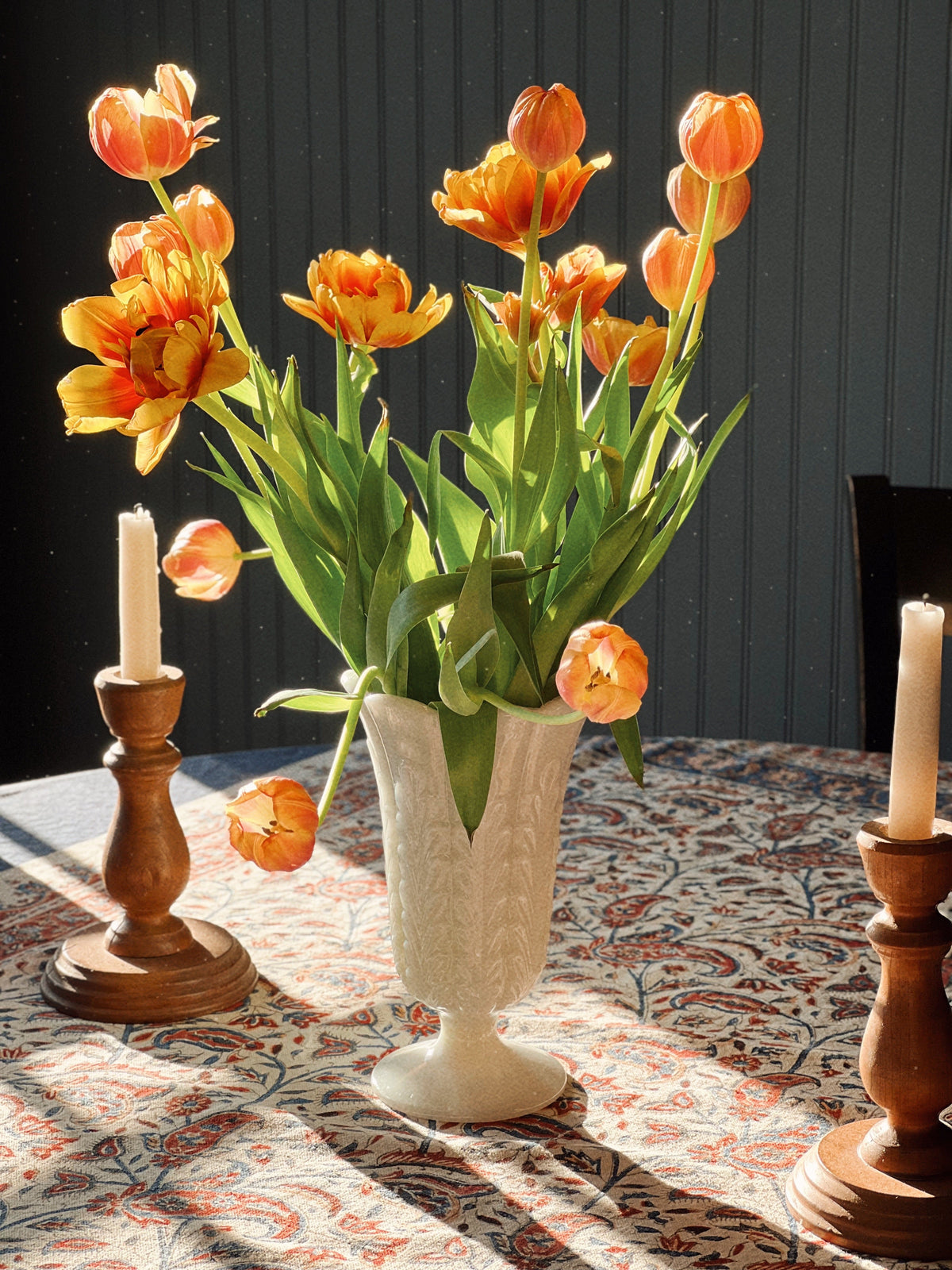 Vintage vases and decorative vessels styled with tulips, candlelight and collected home decor