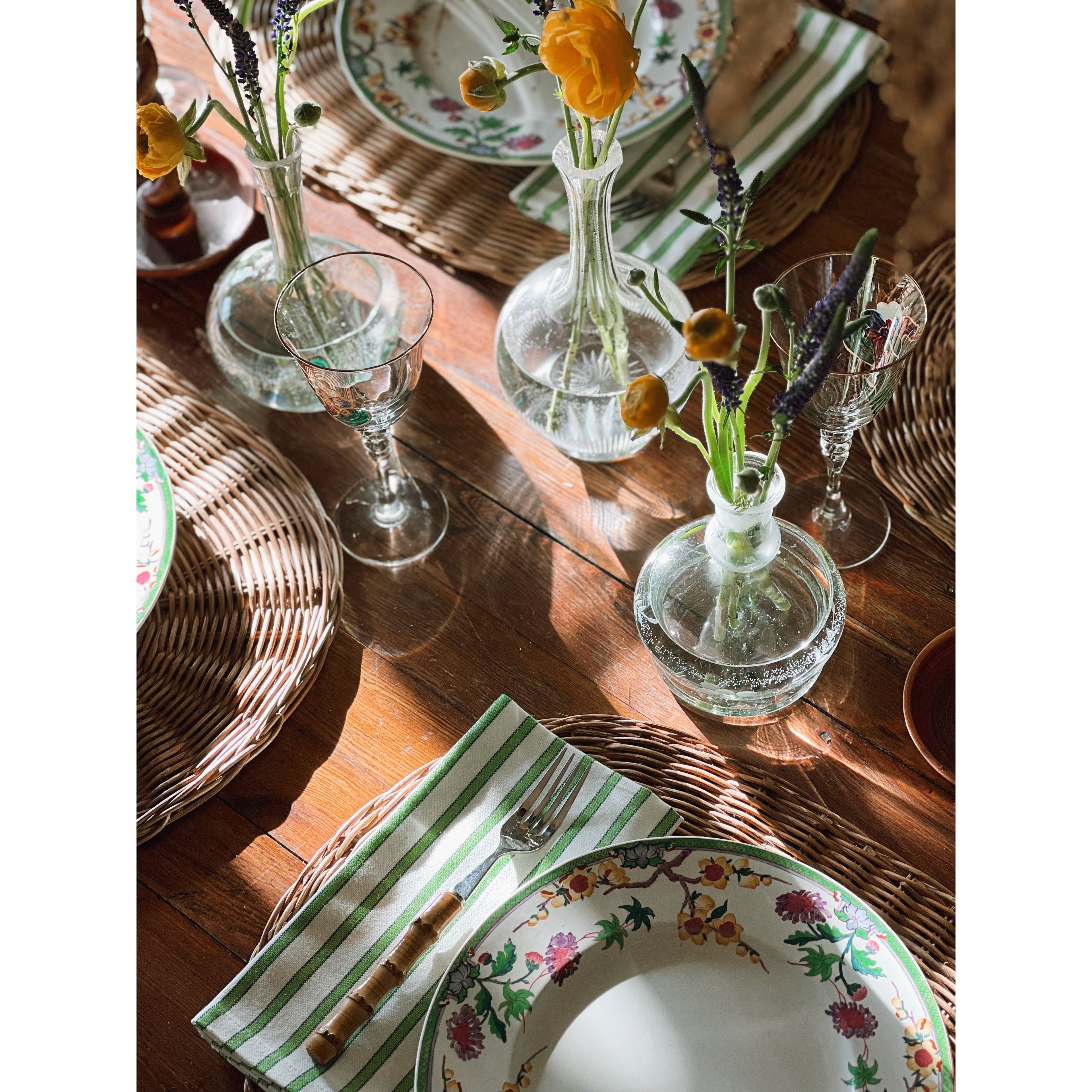Collected Wedgwood china and vintage tableware styled with florals, glassware and layered table settings