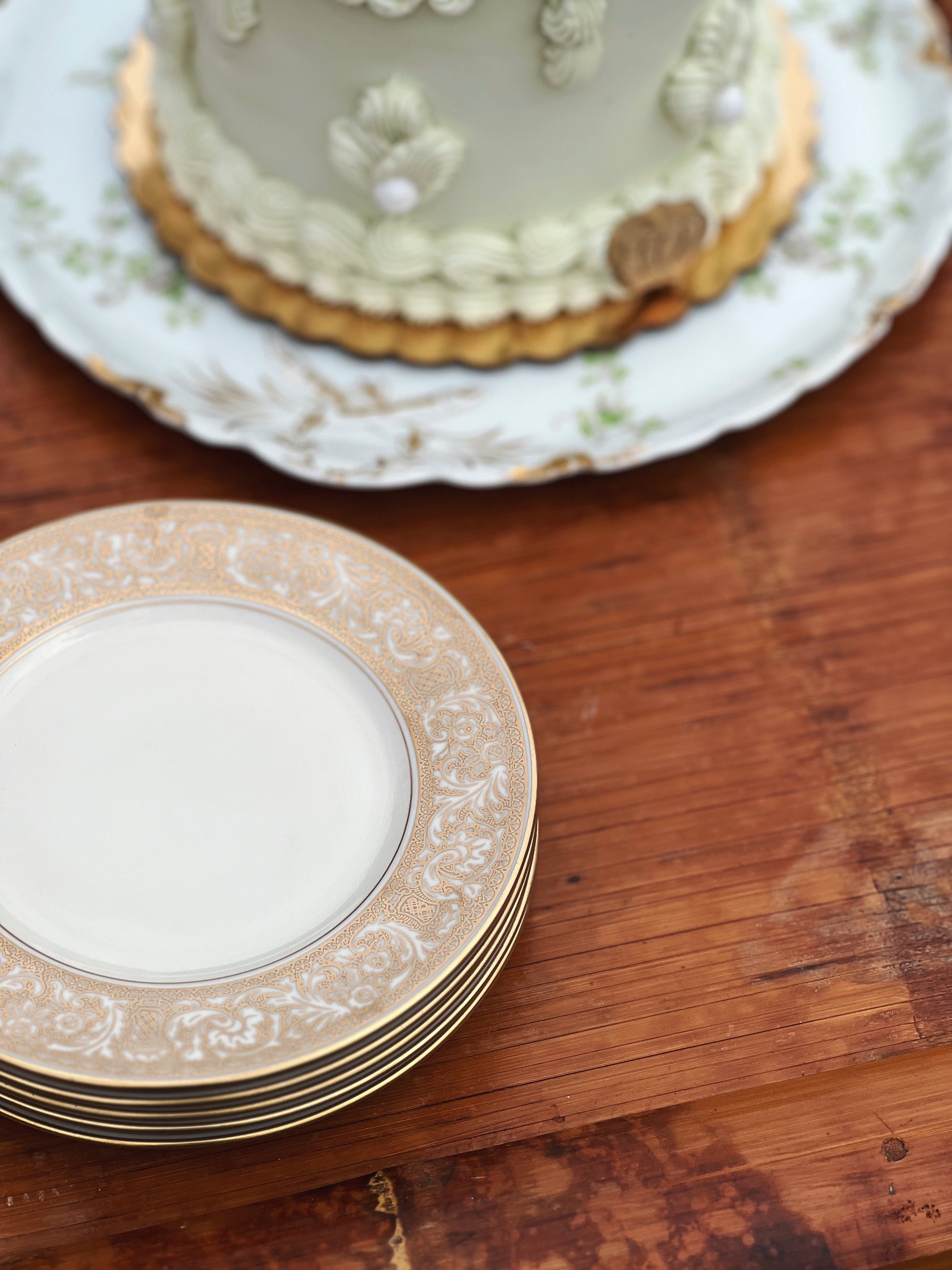 Vintage dessert plates with a vintage style cake on an antique cake plate