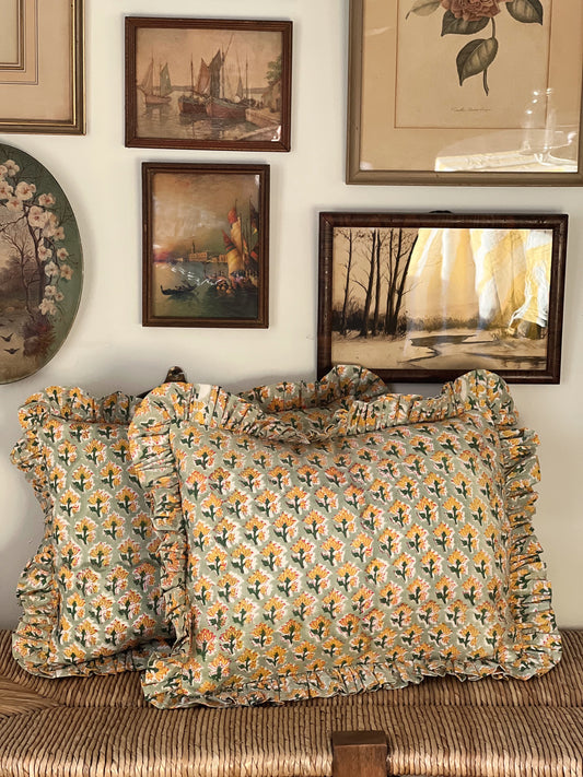 green and yellow throw pillows with a ruffled edge