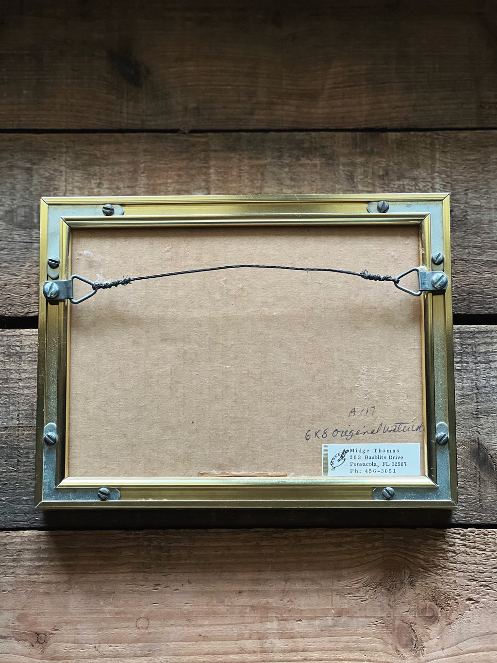 backside of a framed and Signed Midge Thomas Sand Dune Watercolor 