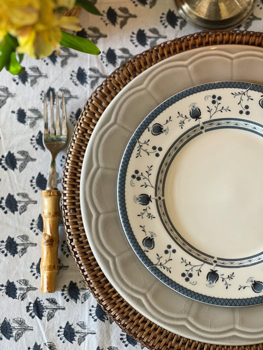 gray scalloped dinner plate with a nay and white floral salad plate on top