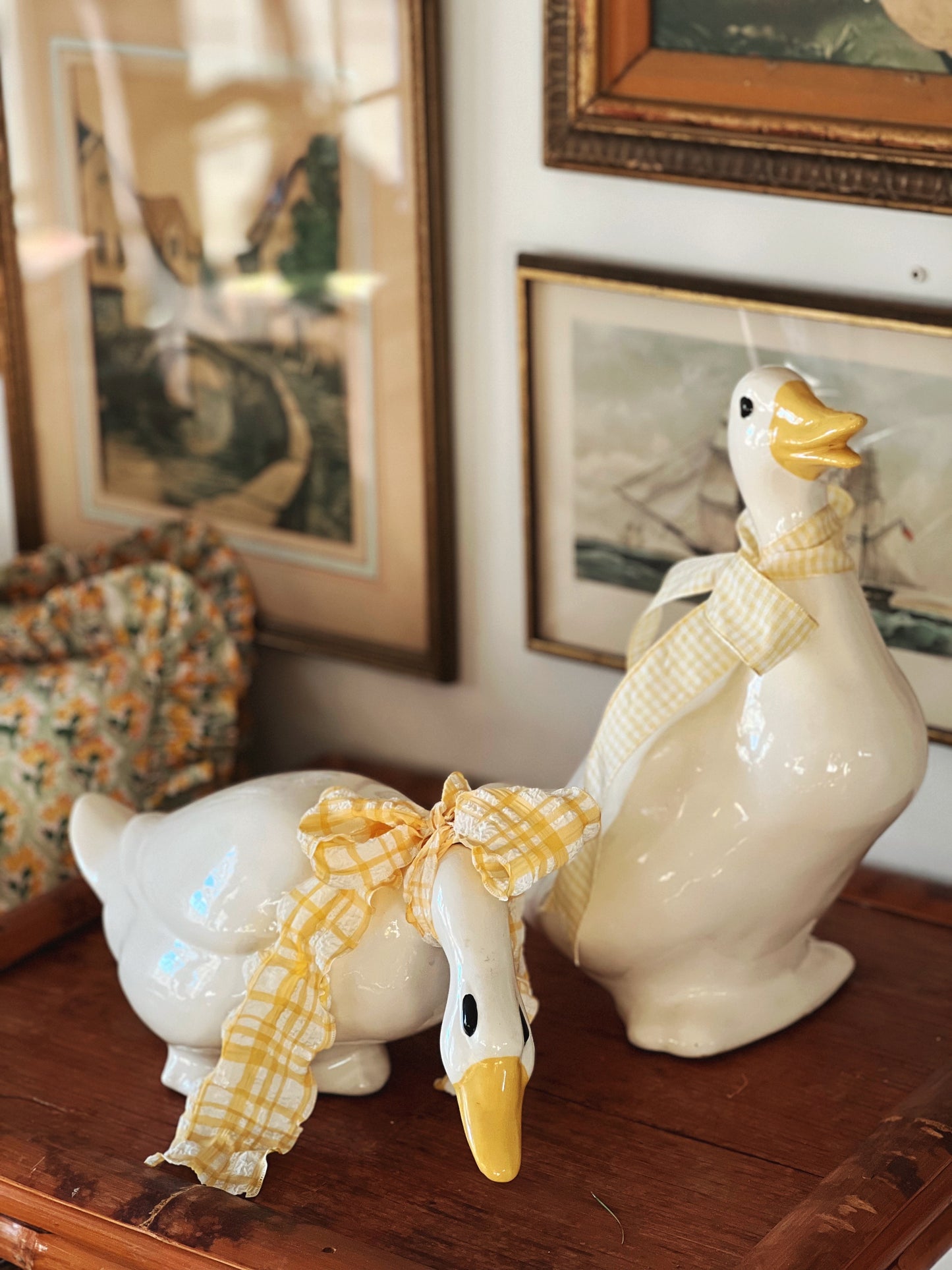 large standing ceramic duck next to a leaning ceramic duck