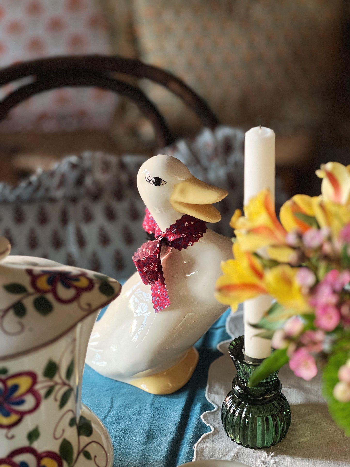 ceramic duck with a ribbon on its neck