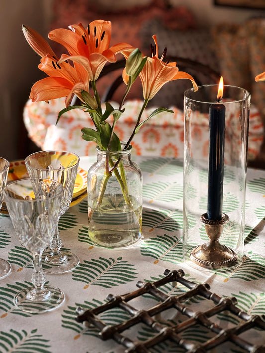 silver candleholder in a hurricane on a table