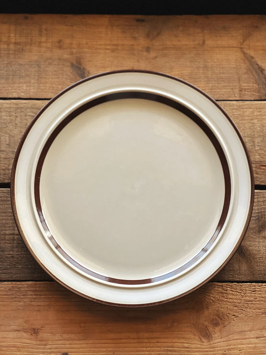 stoneware dinner plate with a white and brown banded rim design