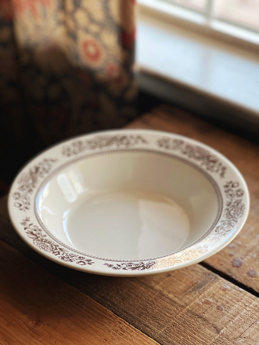 round serving bowl with a brown transferware rim