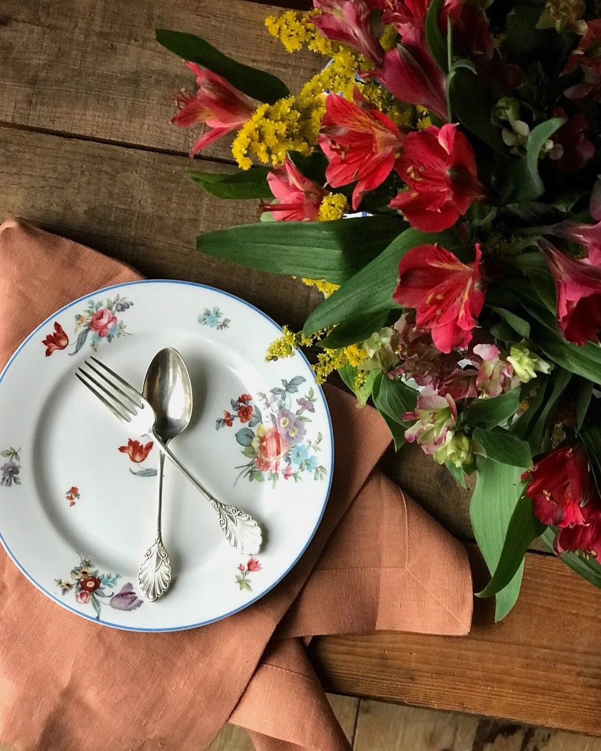 multi color floral salad plate with a blue rim