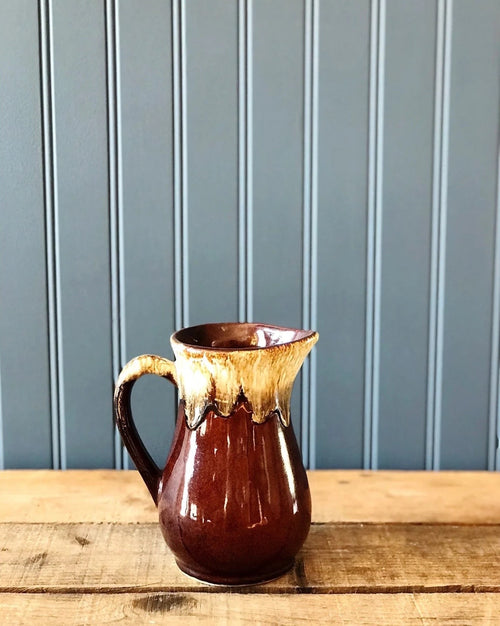 Vintage Roseville Brown Drip Stoneware Pitcher on a rustic wood table