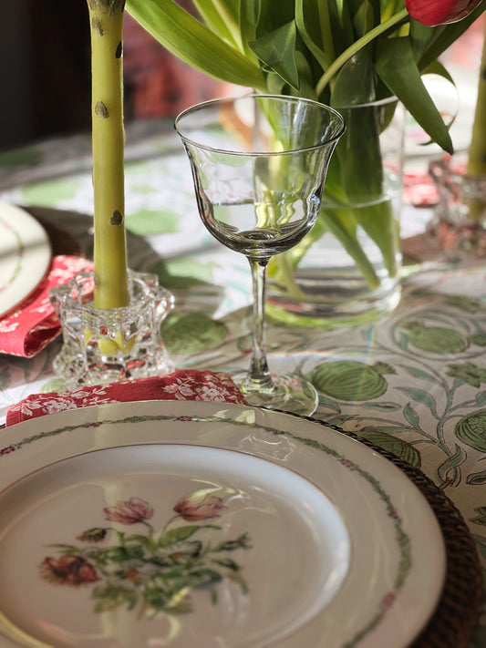 clear glass wine glass on a table set for spring