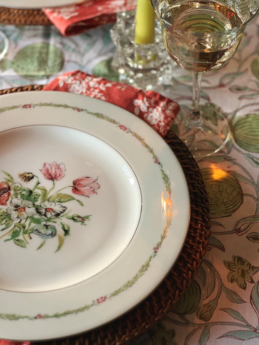 floral dinner plate with a floral napkin on a block print tablecloth