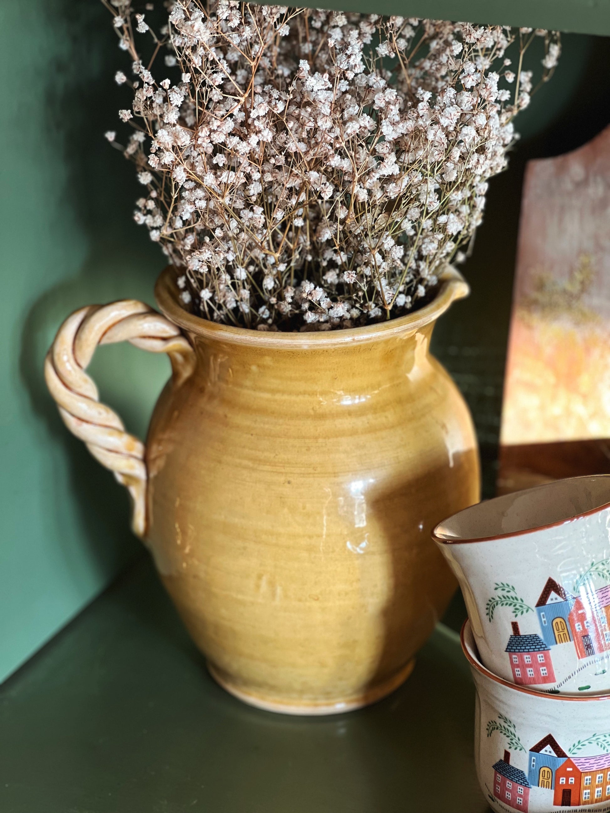 hand painted golden yellow pitcher with a twist handle