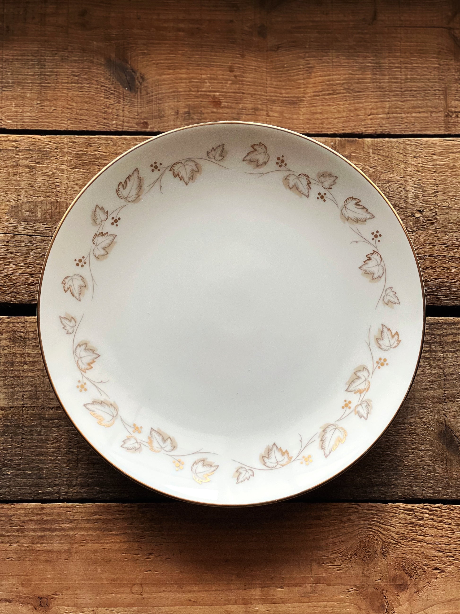 white salad plate with gold ivy leaves around the rim