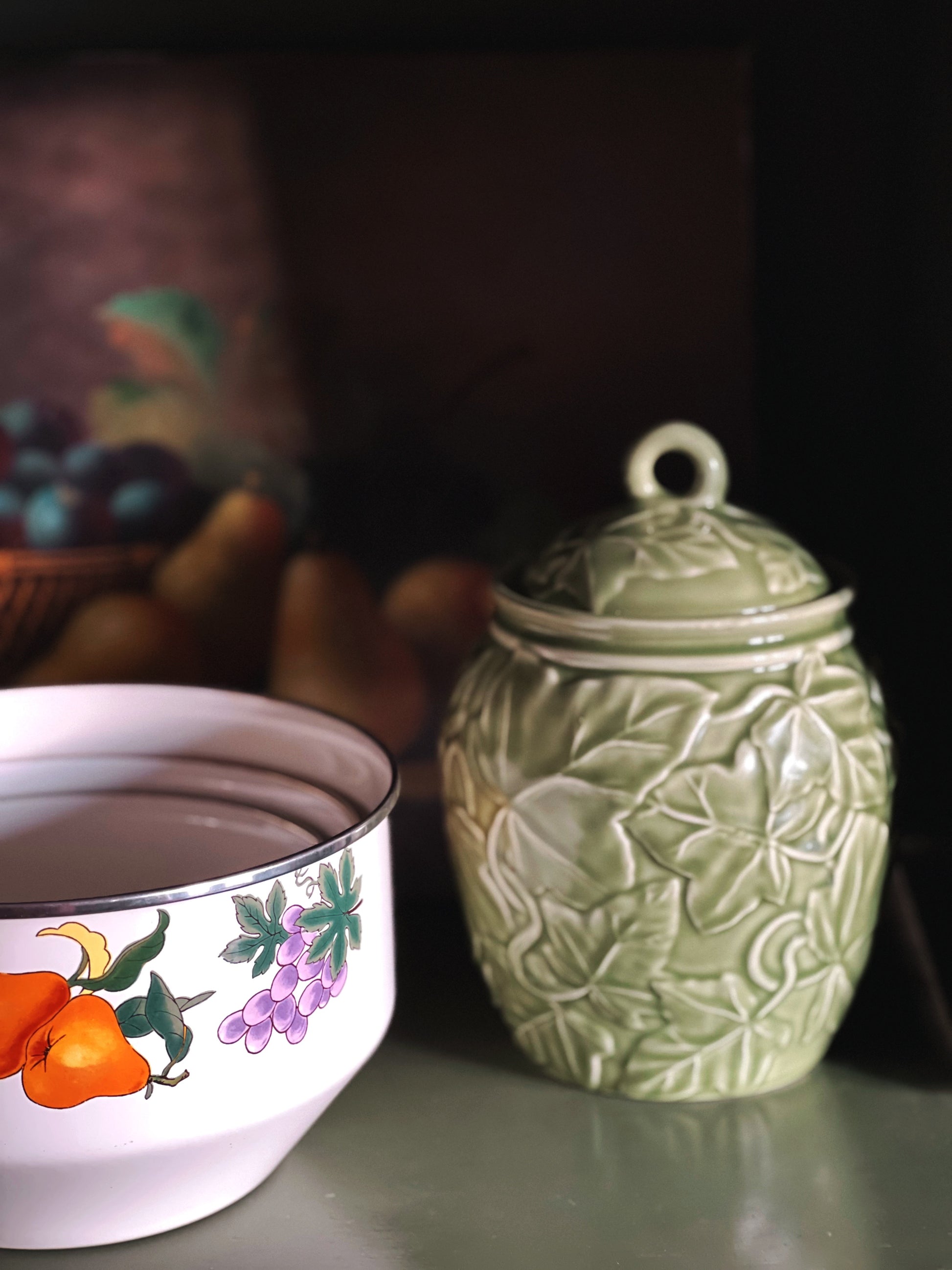 embossed green canister with an ivy leaf pattern