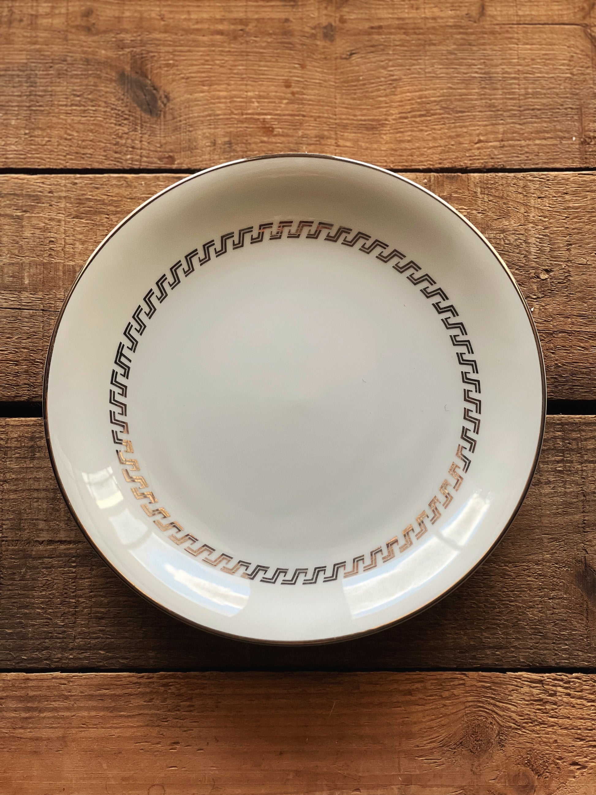 white plate with a silver geometric design