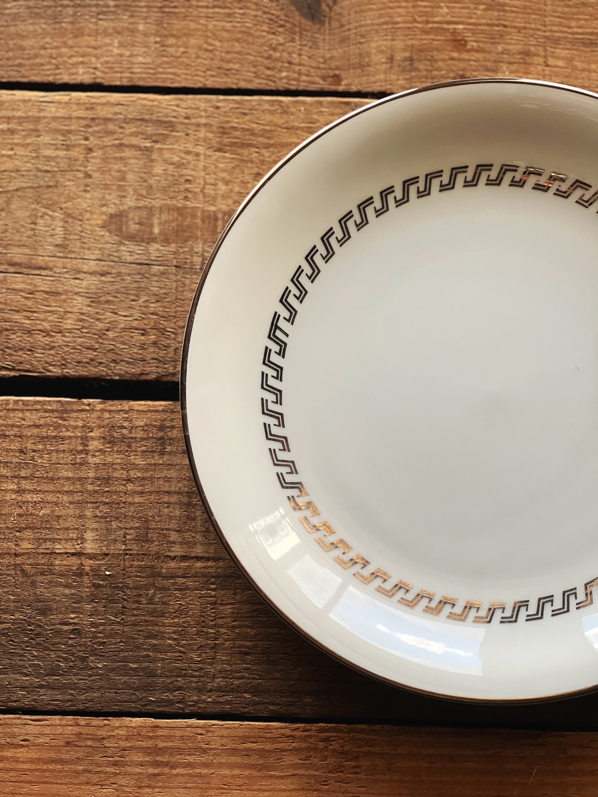 white plate with a silver geometric design