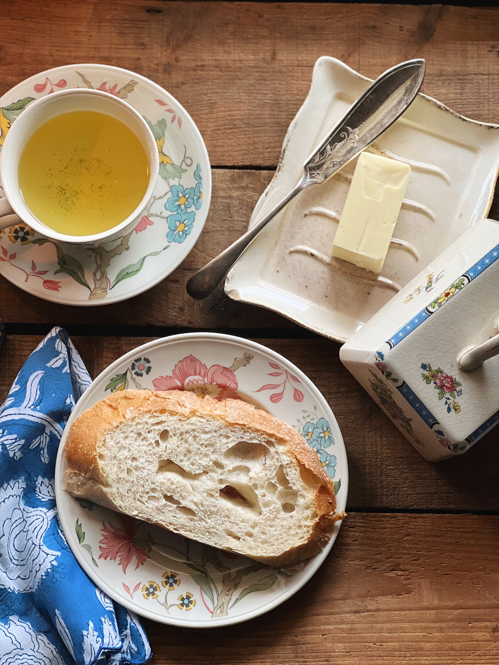 breakfast table with tea and toast and butter in a butter dish