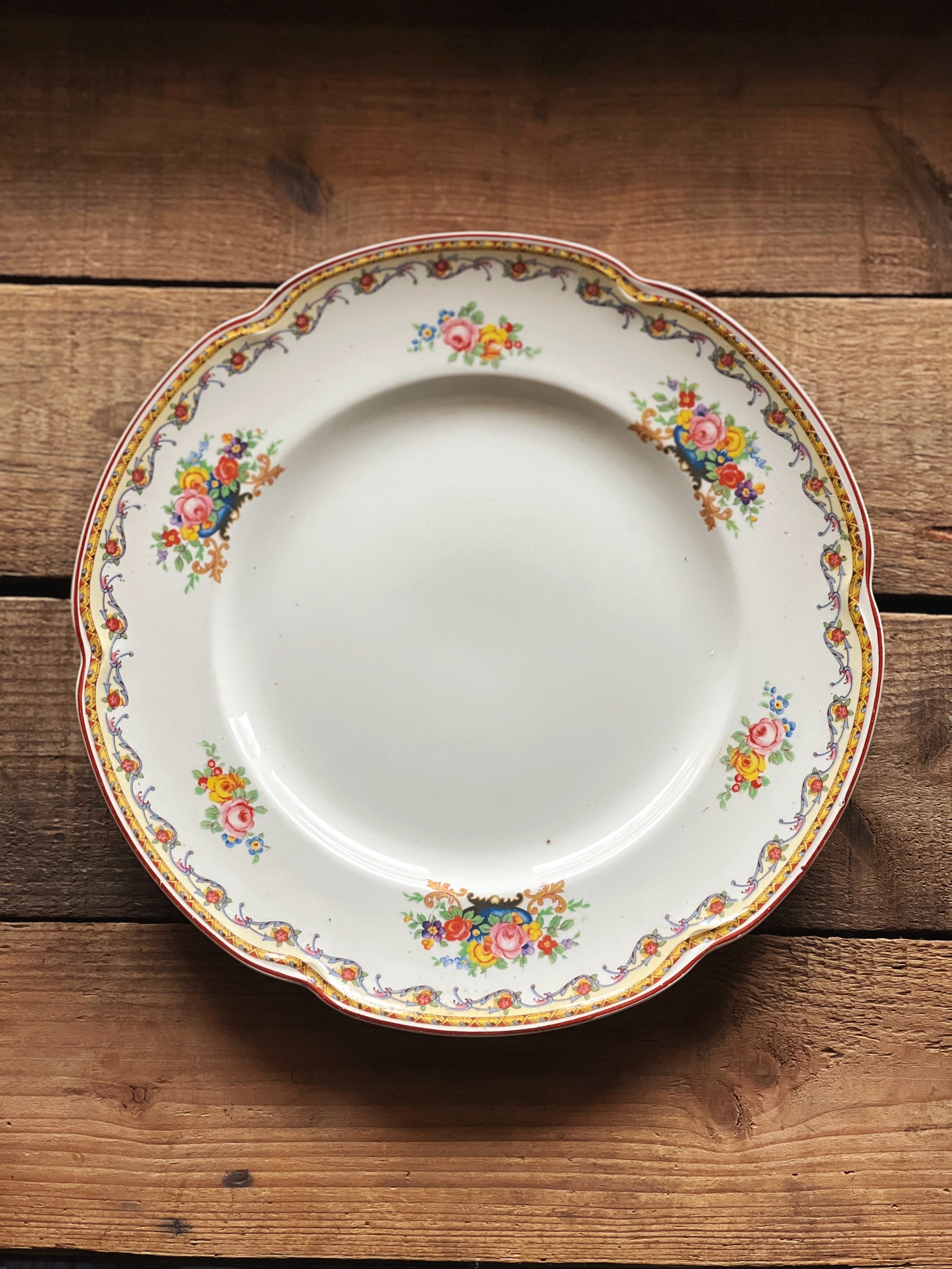 multicolor floral dinner plate with a garland design rim