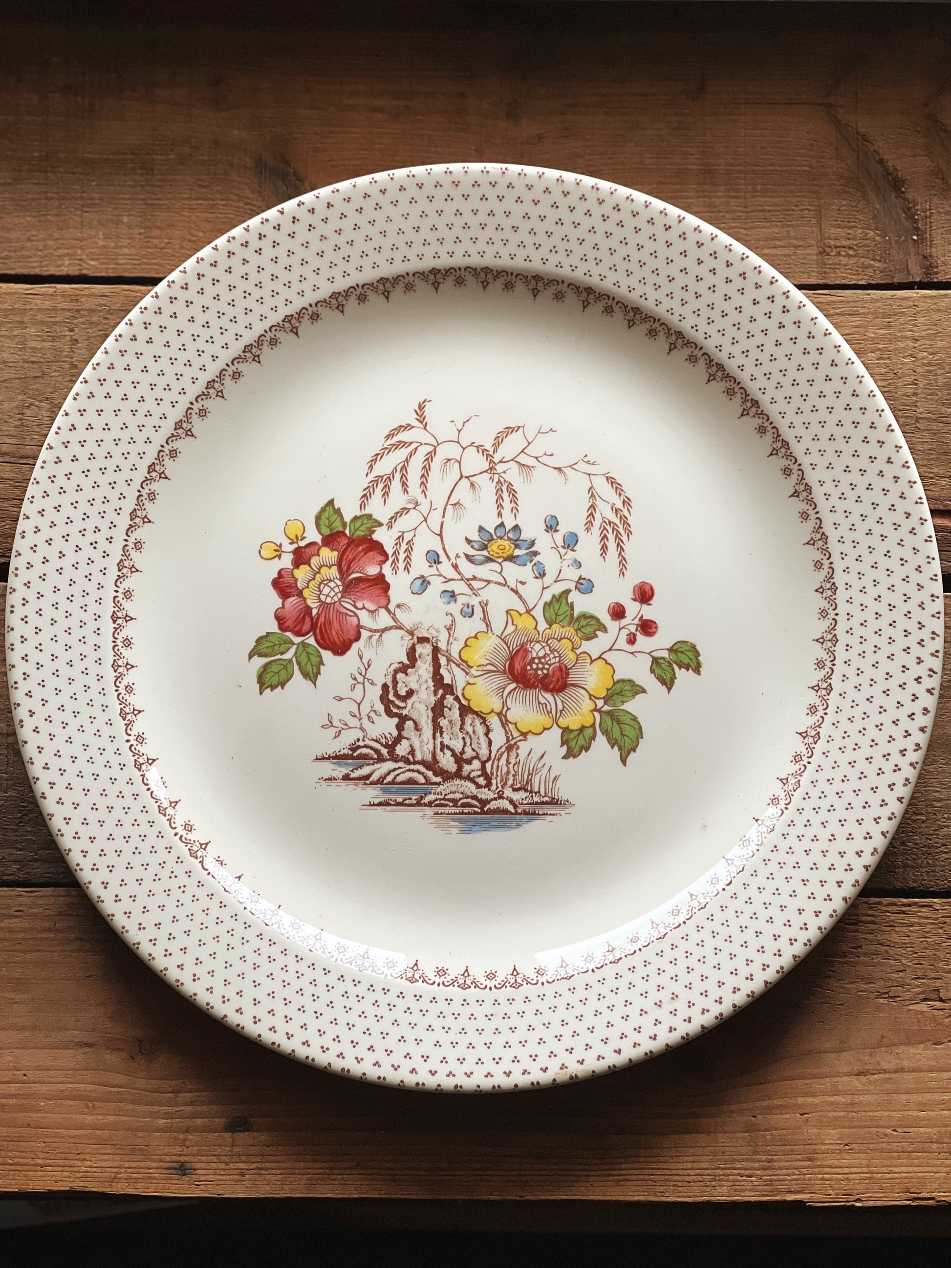 floral serving platter with a brown pattern rim