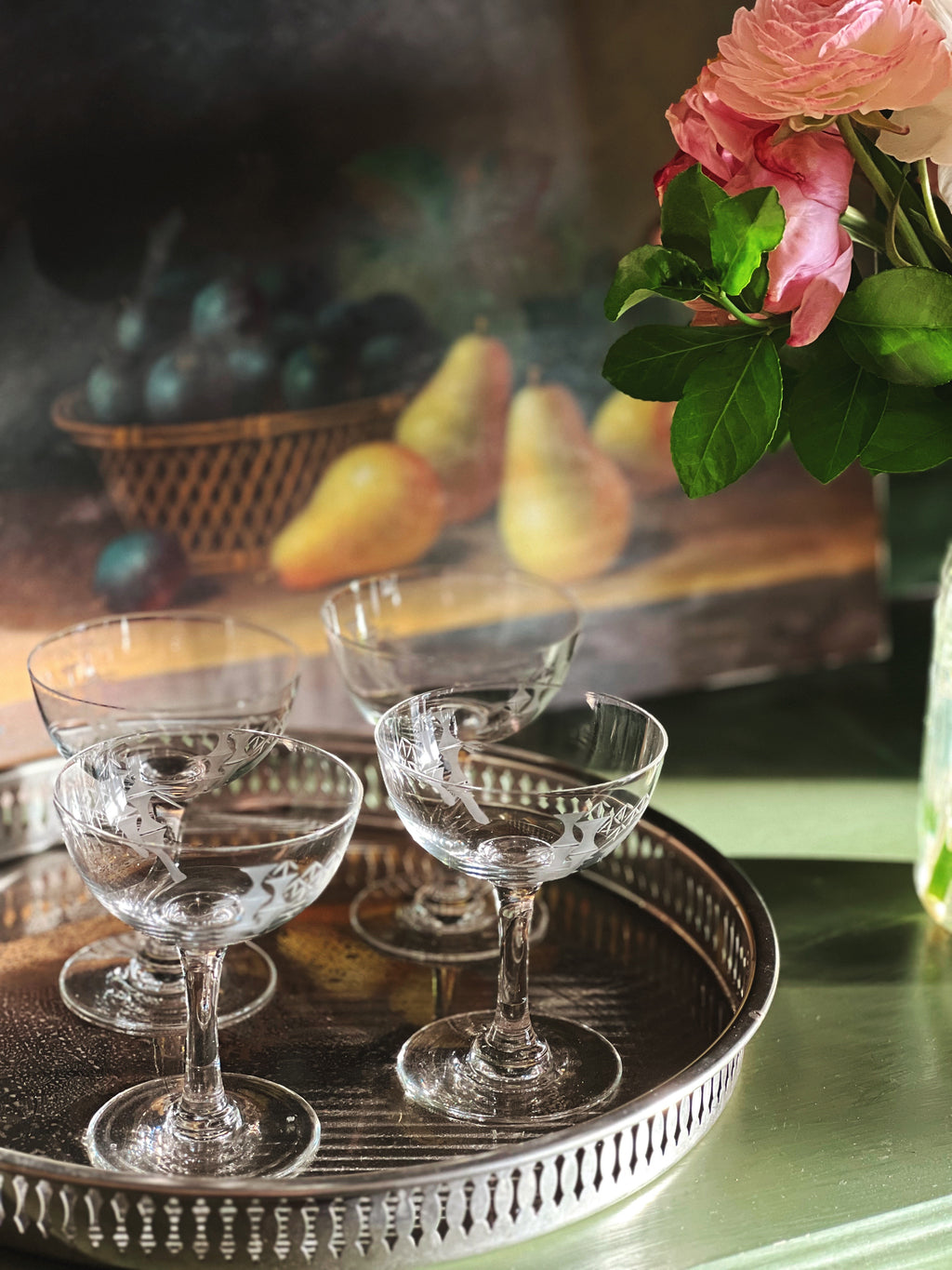 etched bamboo champagne coupes on a silver tray