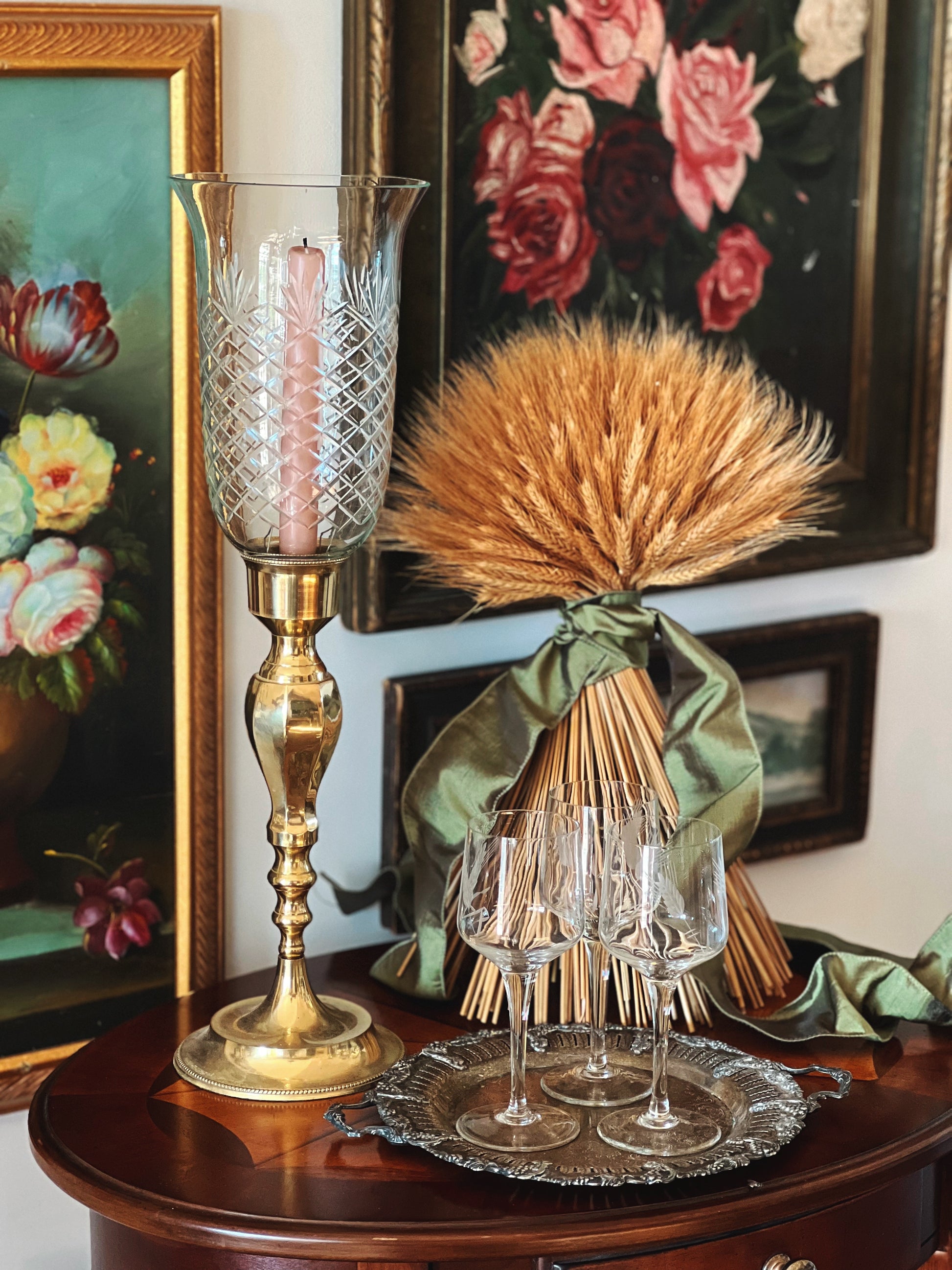 brass and cut glass hurricane lamp on a side table 