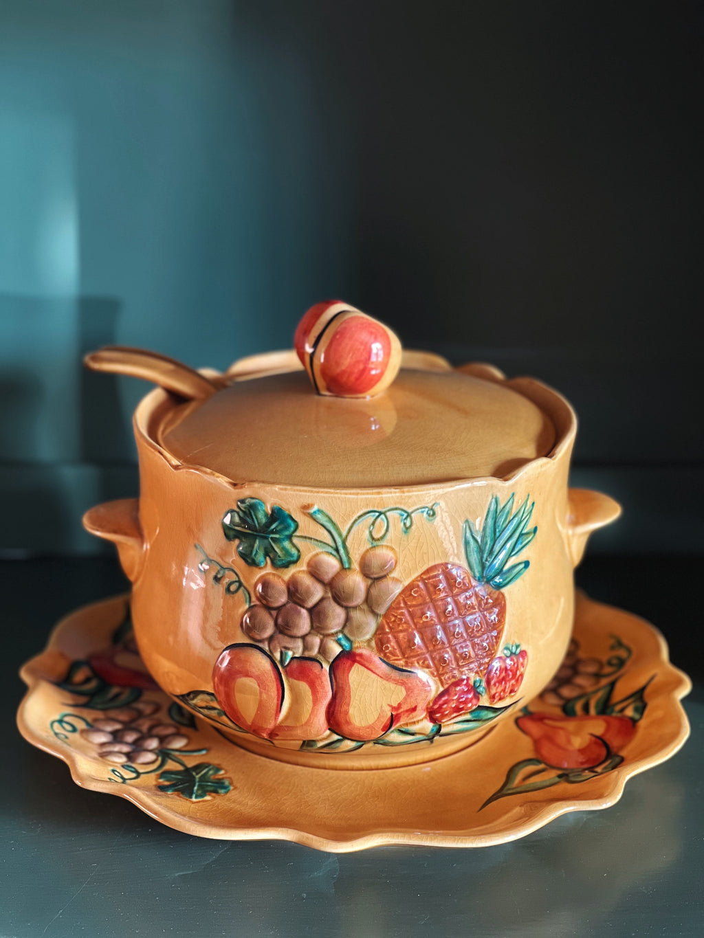 multi color soup tureen with a fruit design across the surface