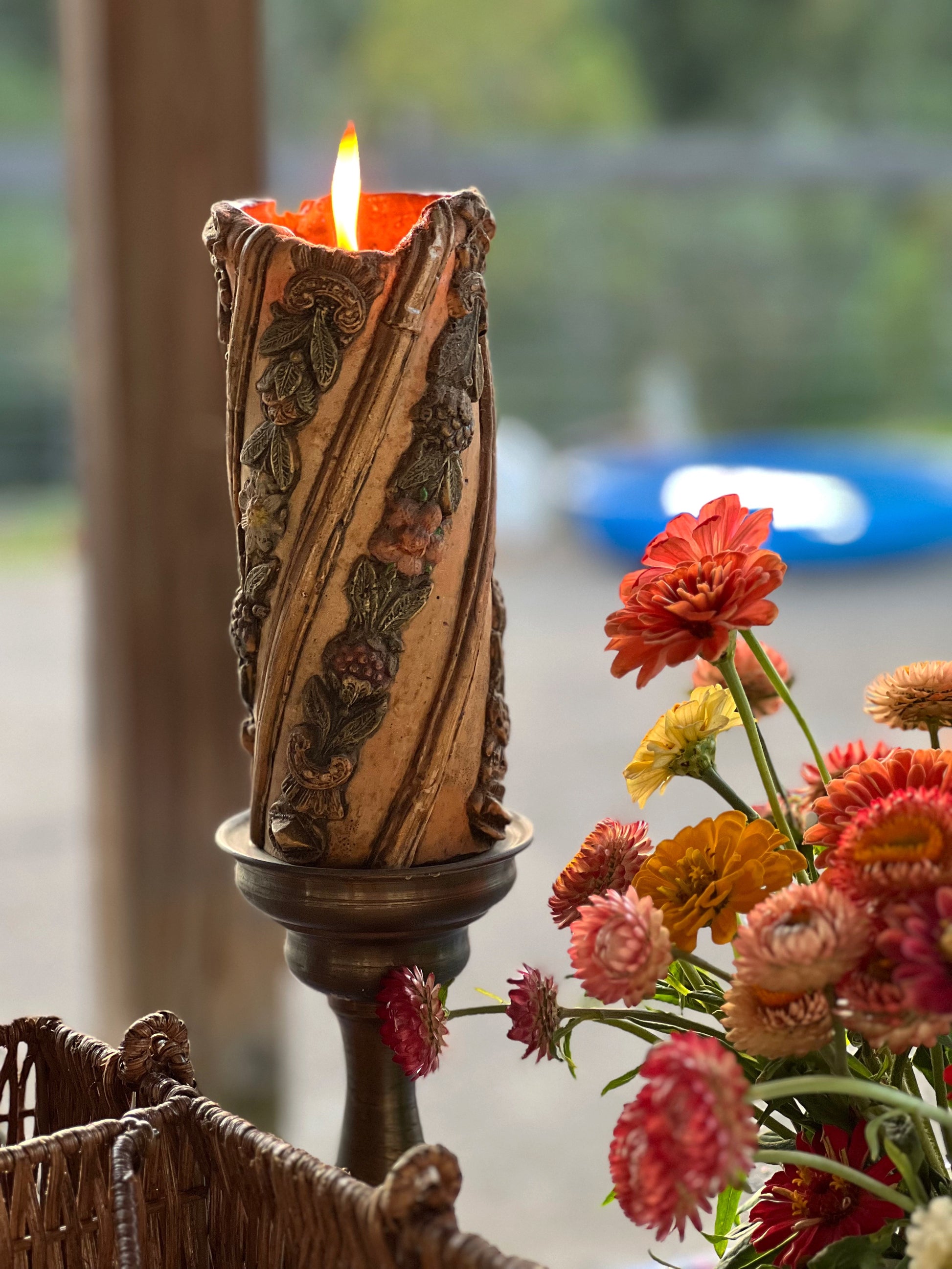 vintage carved pillar candle on a brass candle holder