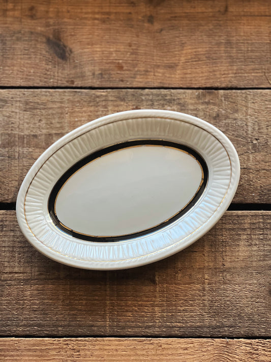 small oval platter with a black banded design