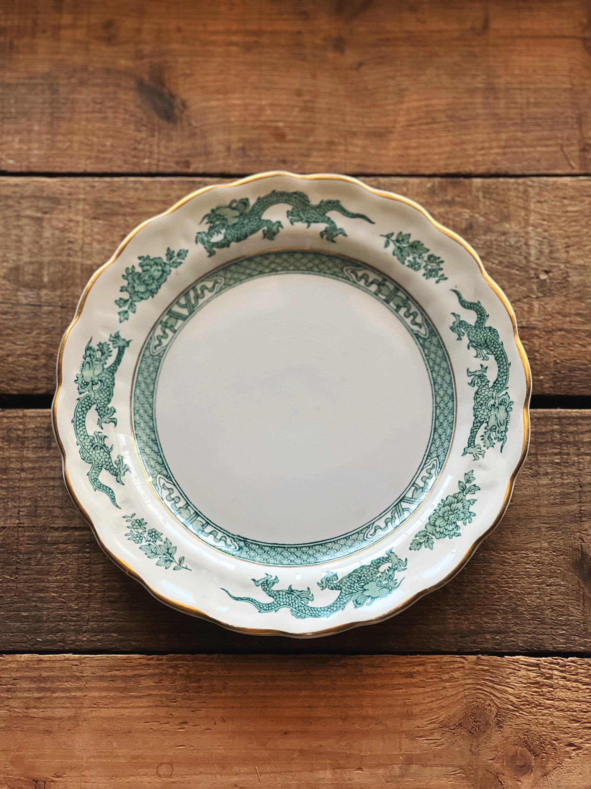 scalloped rim salad plate with a blue/green dragon design 