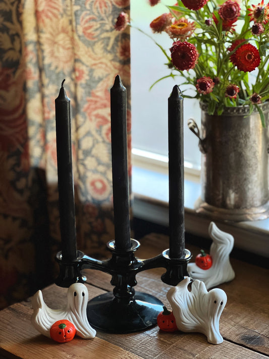 vintage ghost figurines with a black candelabra