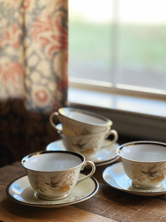 black and gold hand painted teacups