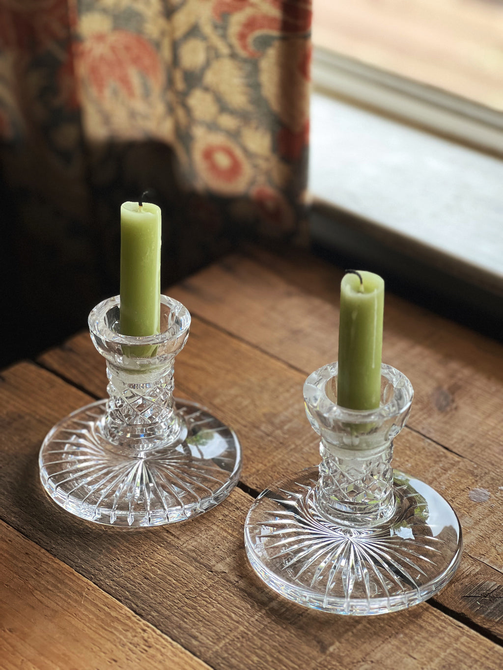pair of Waterford crystal candleholders on a wooden table