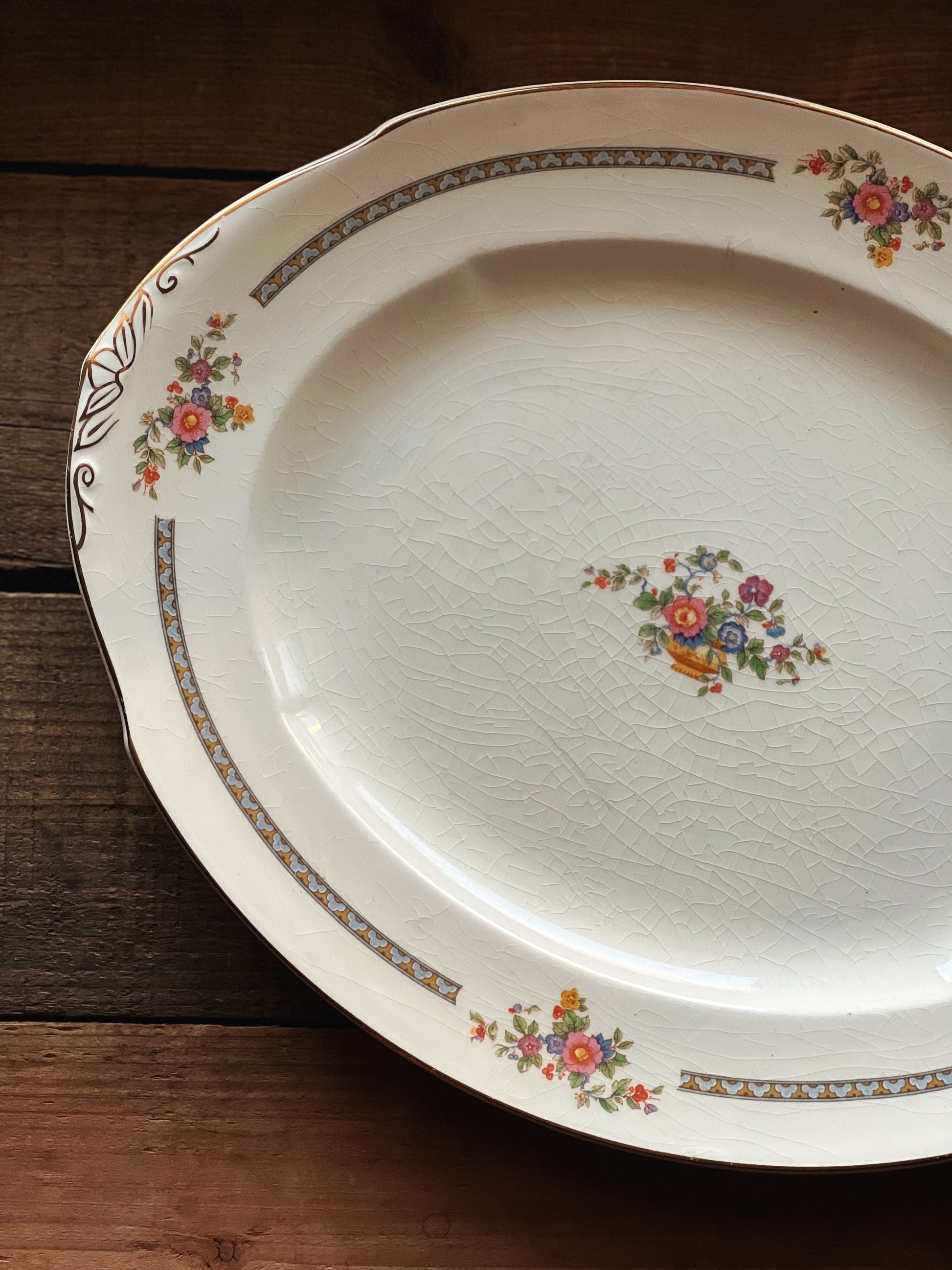 Decorative plate with floral patterns on a wooden surface