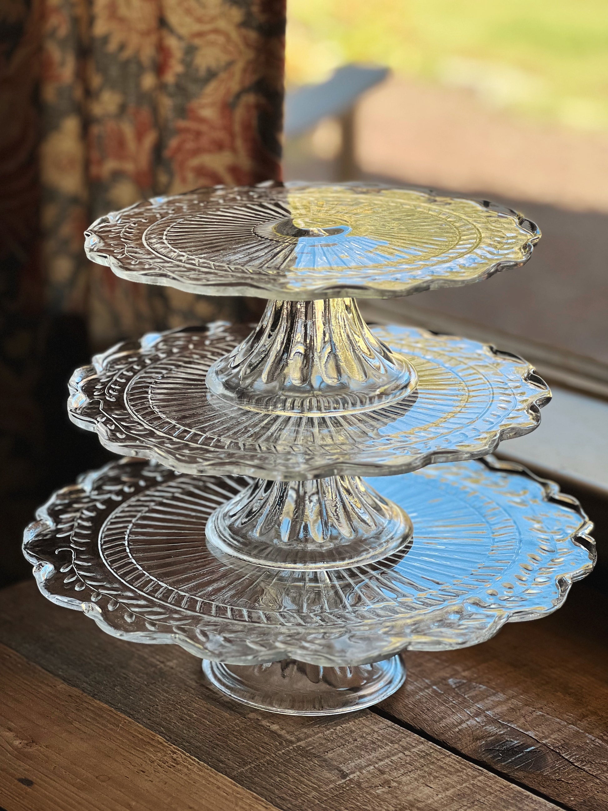 trio of stacked clear glass cake stands