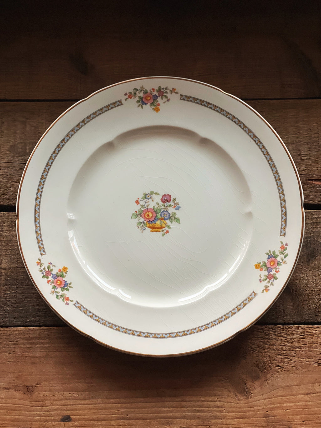 Decorative plate with floral design on a wooden surface