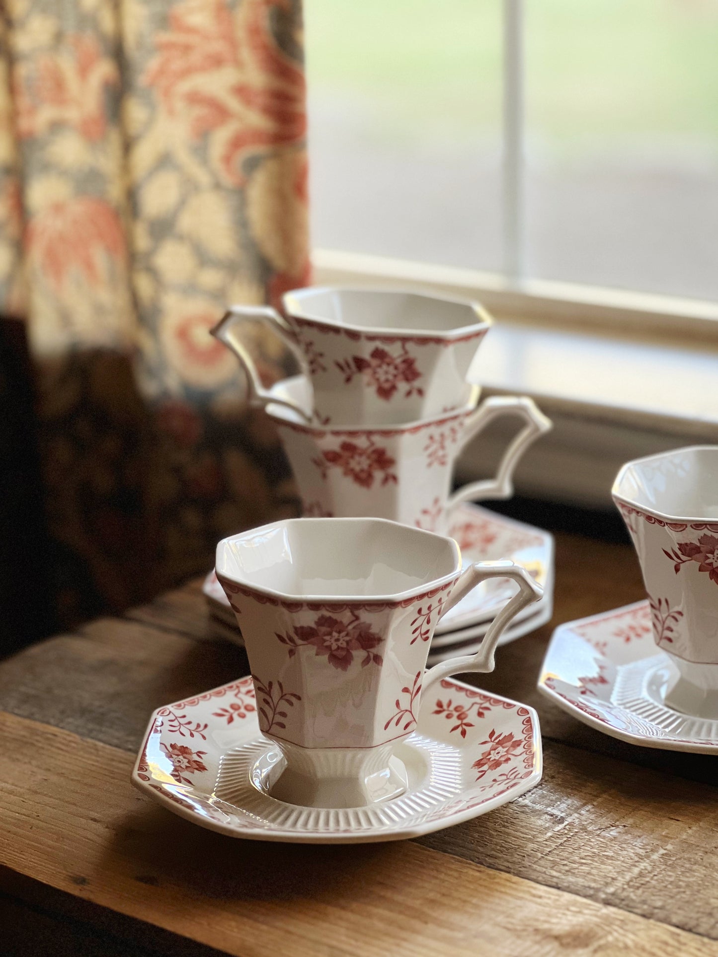 red and white floral teacup and saucers