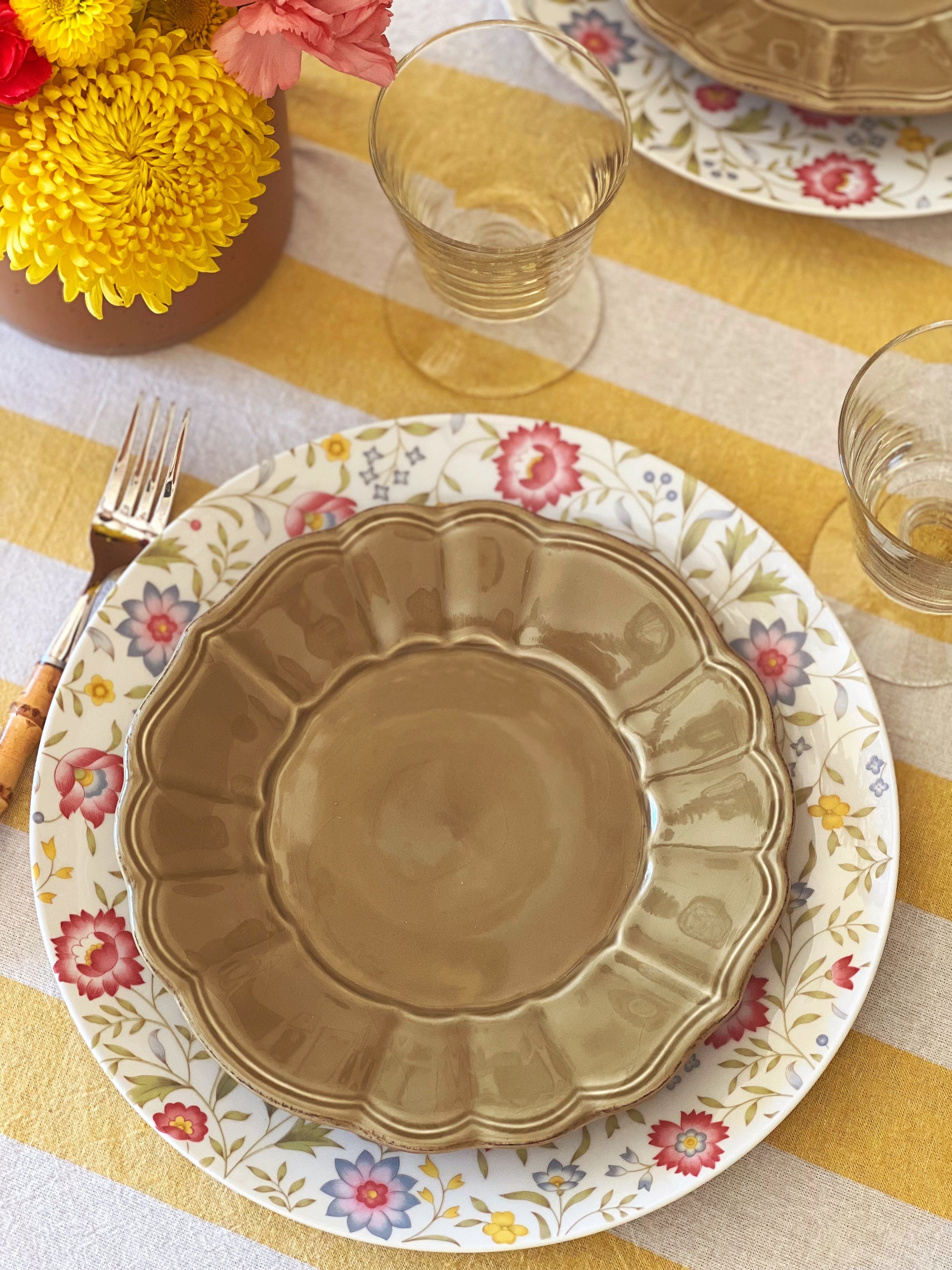 green scalloped edge salad plate on top of a floral plate