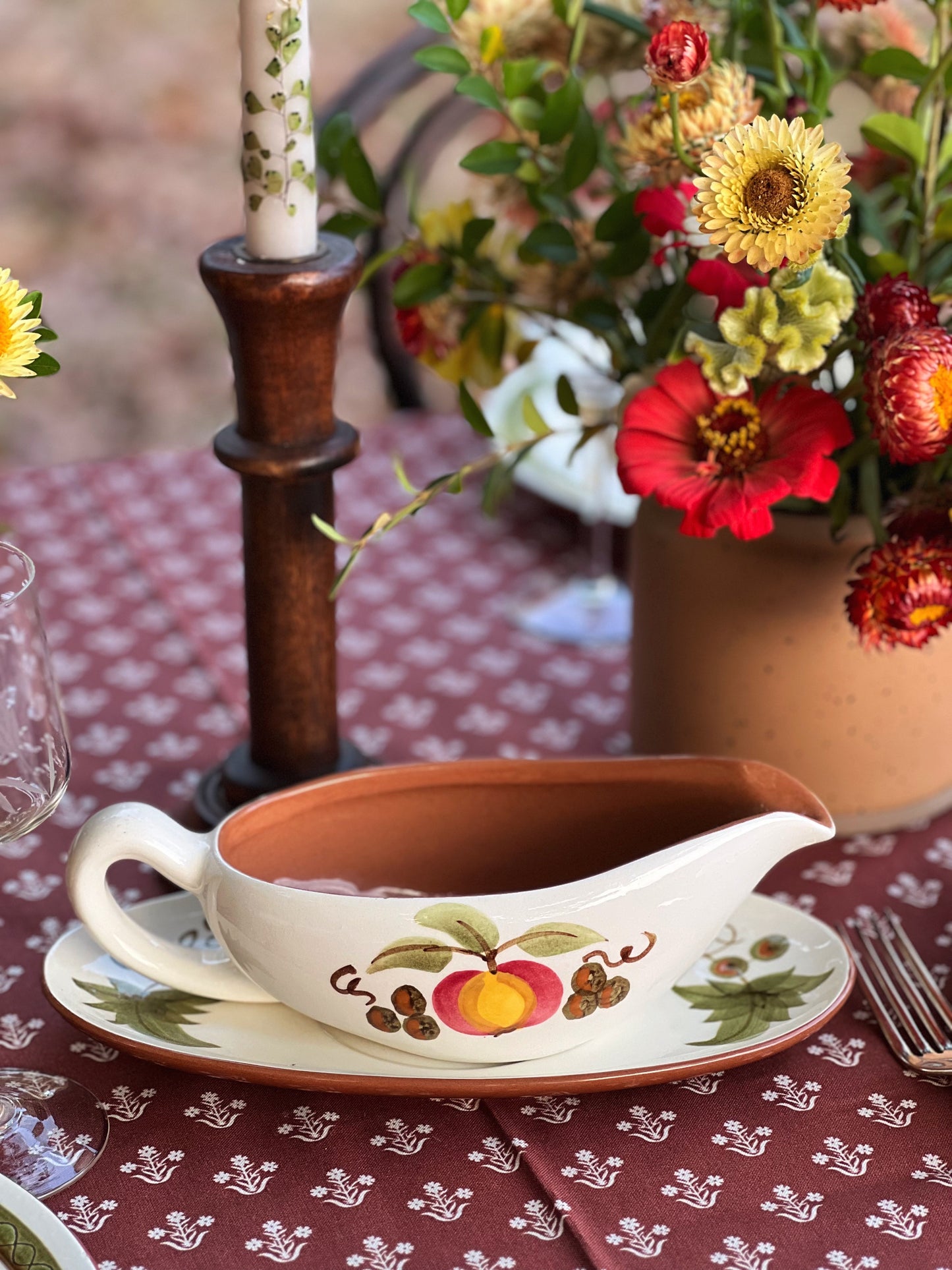 hand painted gravy boat on a table outside in fall