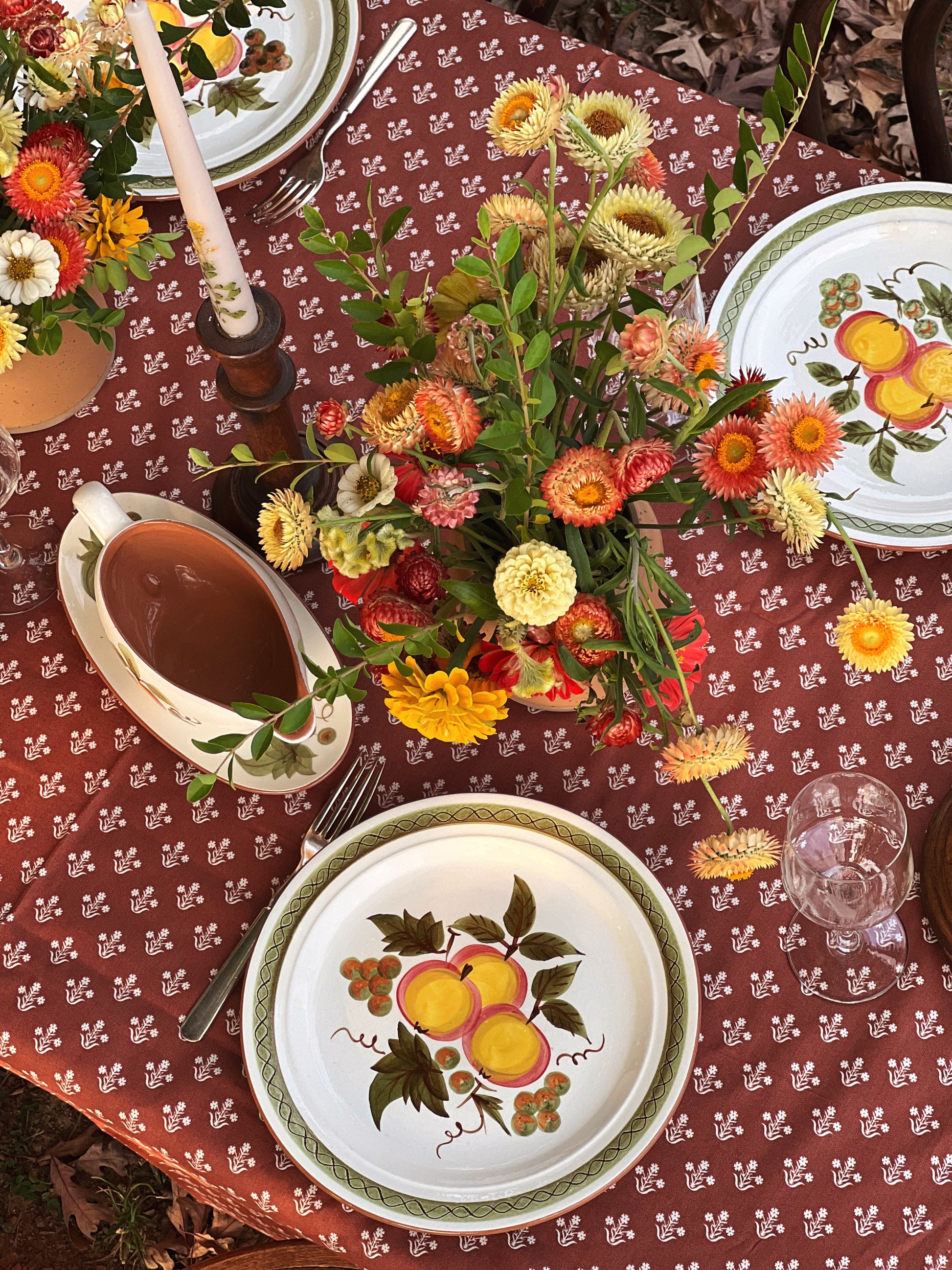 outdoor table set for fall with apple pattern dinner plates