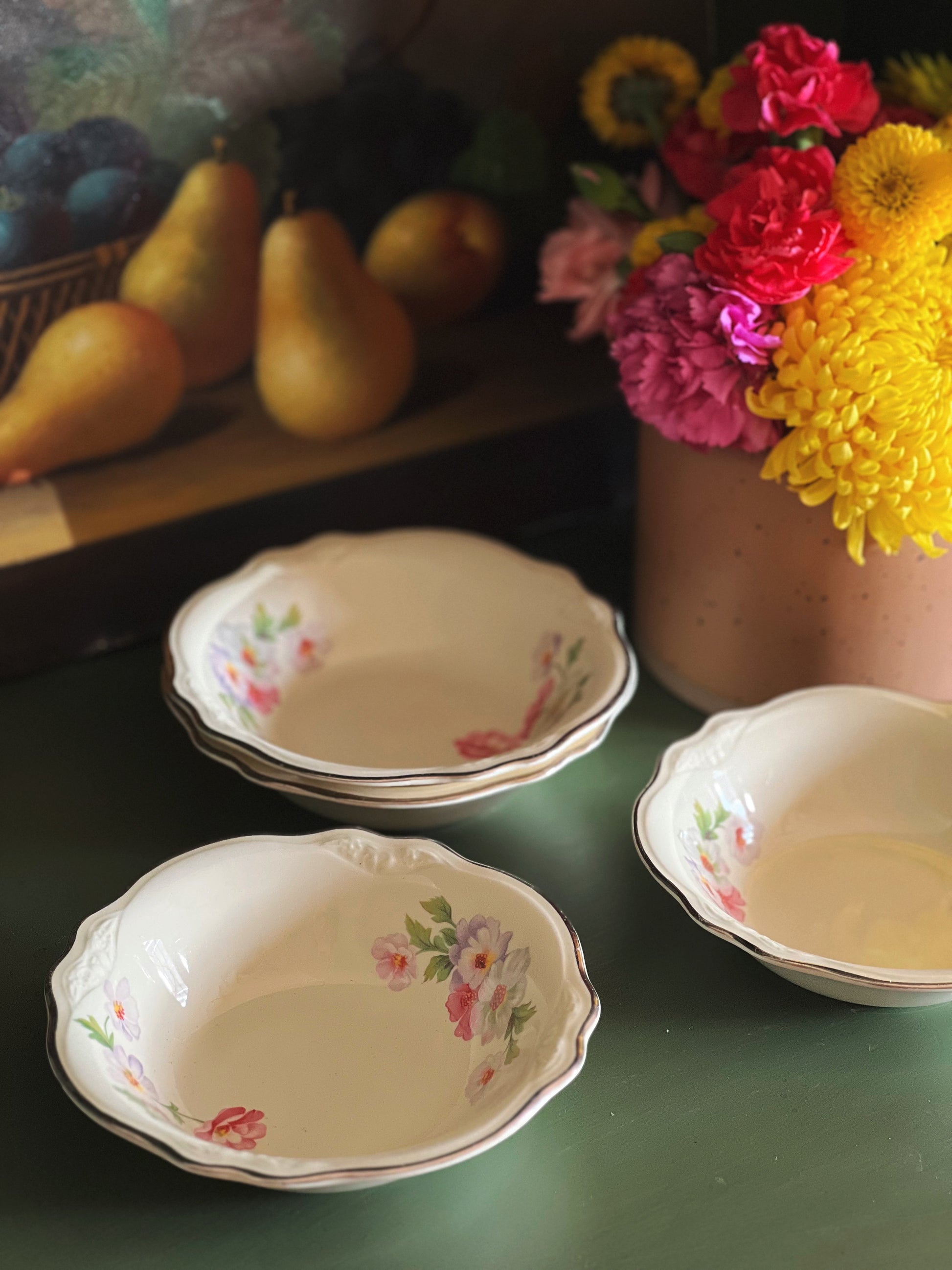 three pink, white and green berry bowls on a table
